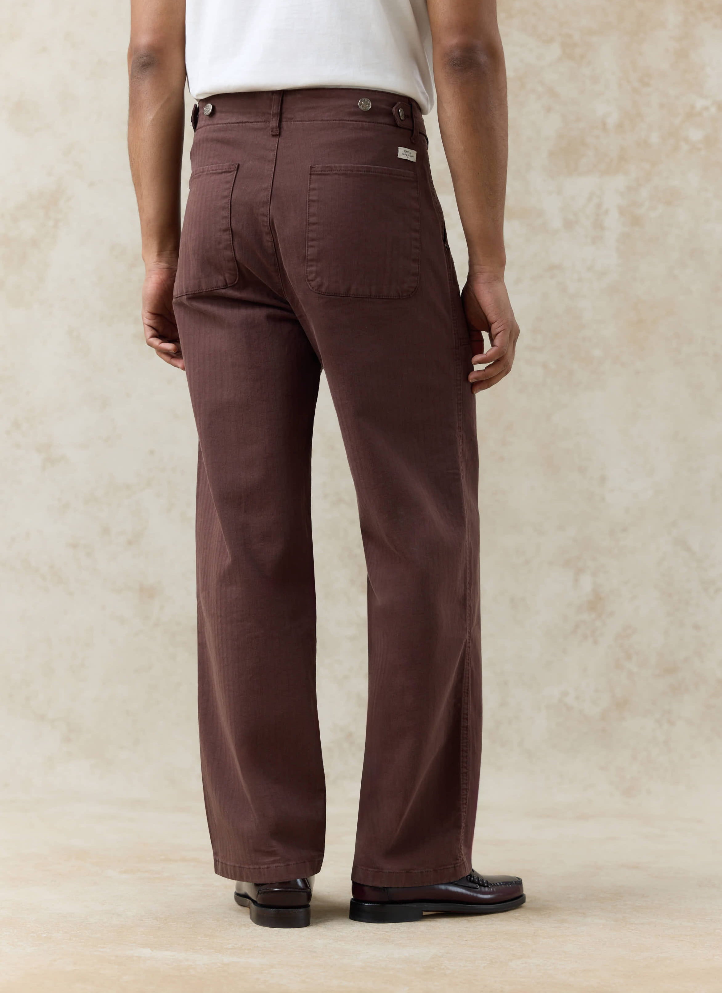 Percival Lungo Herringbone Straight Trousers in espresso cotton, showing the rear view and back patch pockets.