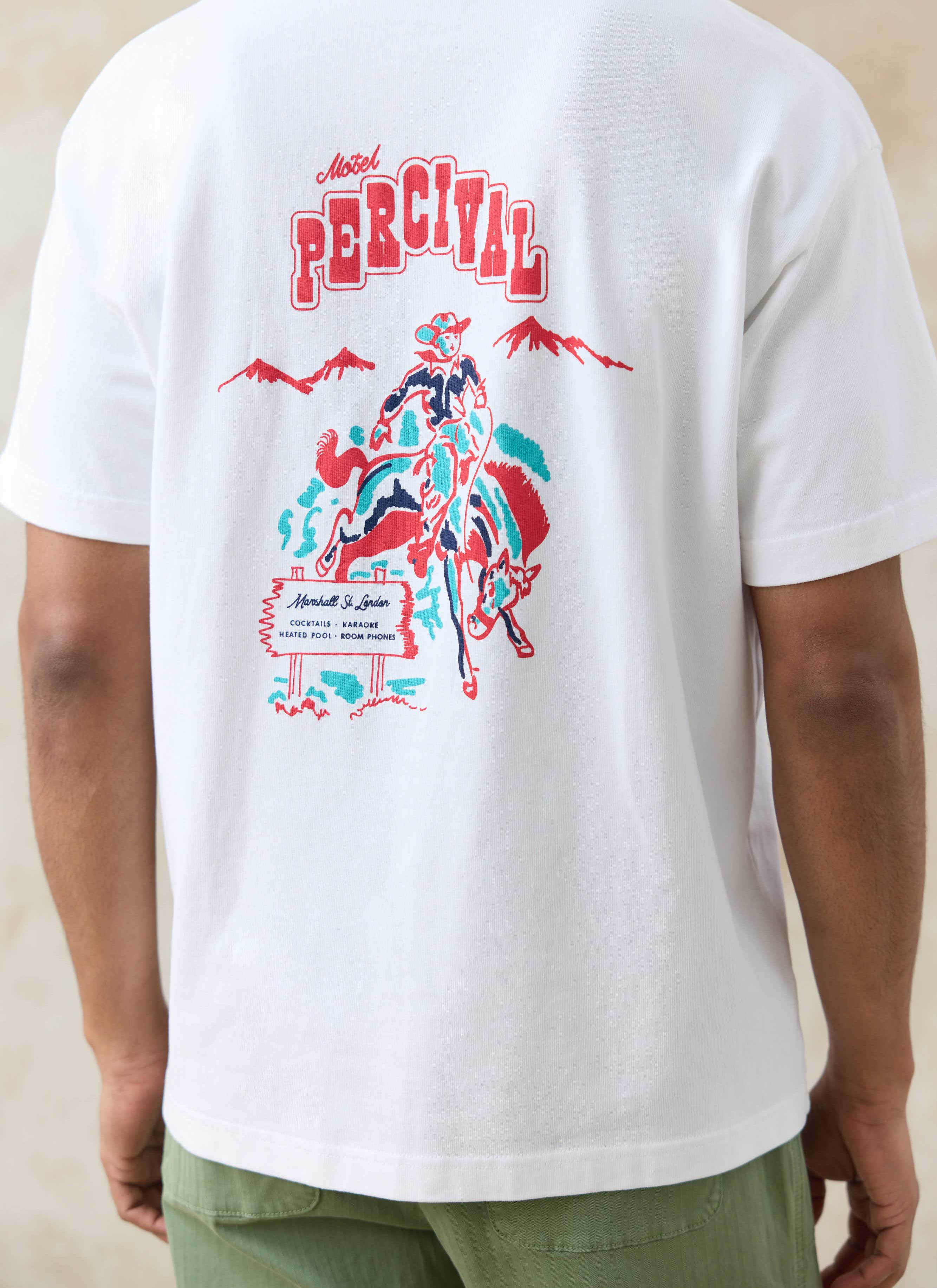 Large red and teal Motel Percival cowboy graphic on the back of the white organic cotton oversized T Shirt by Percival.