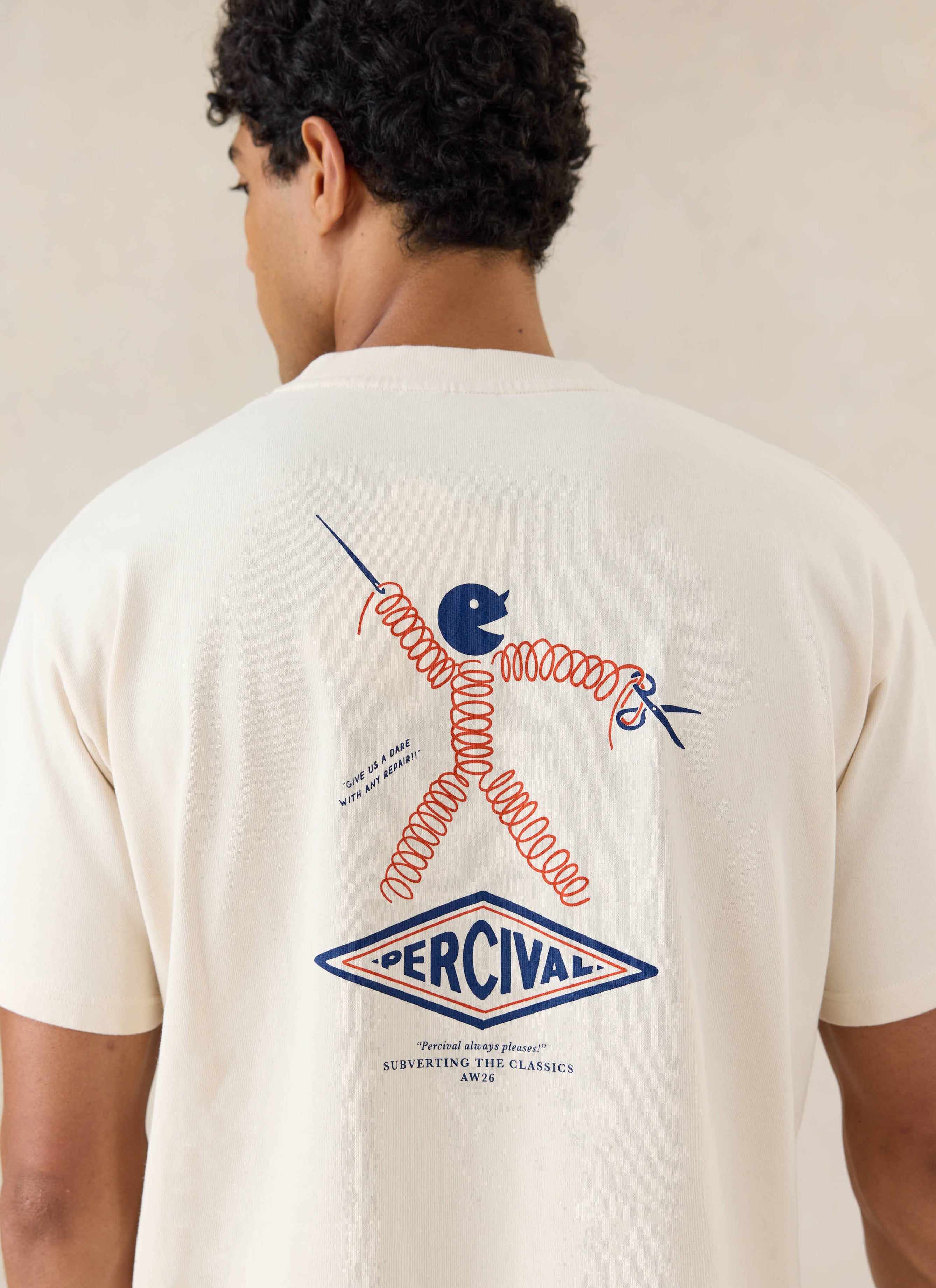 A close-up of a model wearing the cream Percival graphic T-shirt, showing the detailed back print.