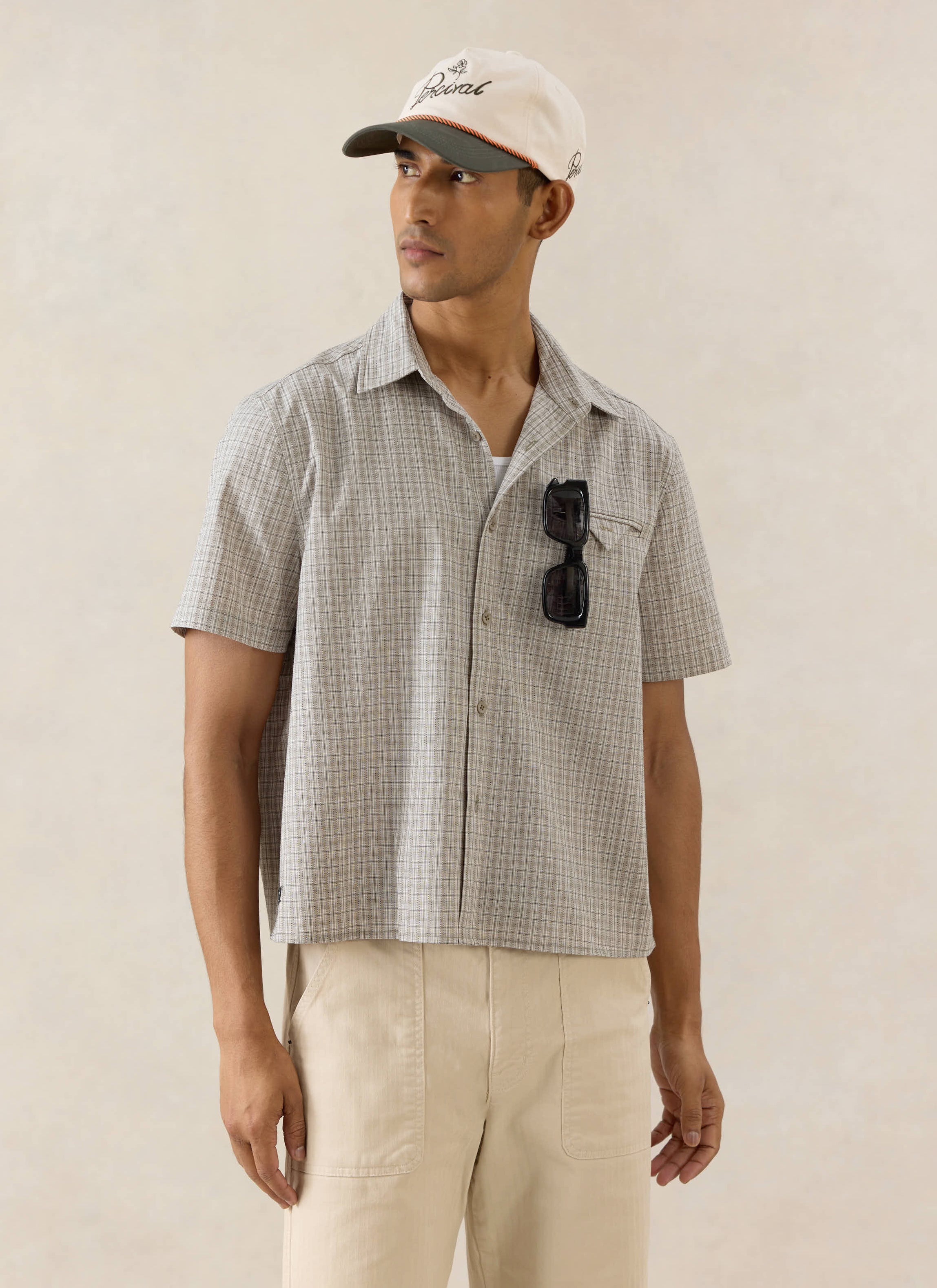 Percival Hinsley boxy short sleeve shirt in cream check cotton, styled with a Spencer cap and Lucas trousers.