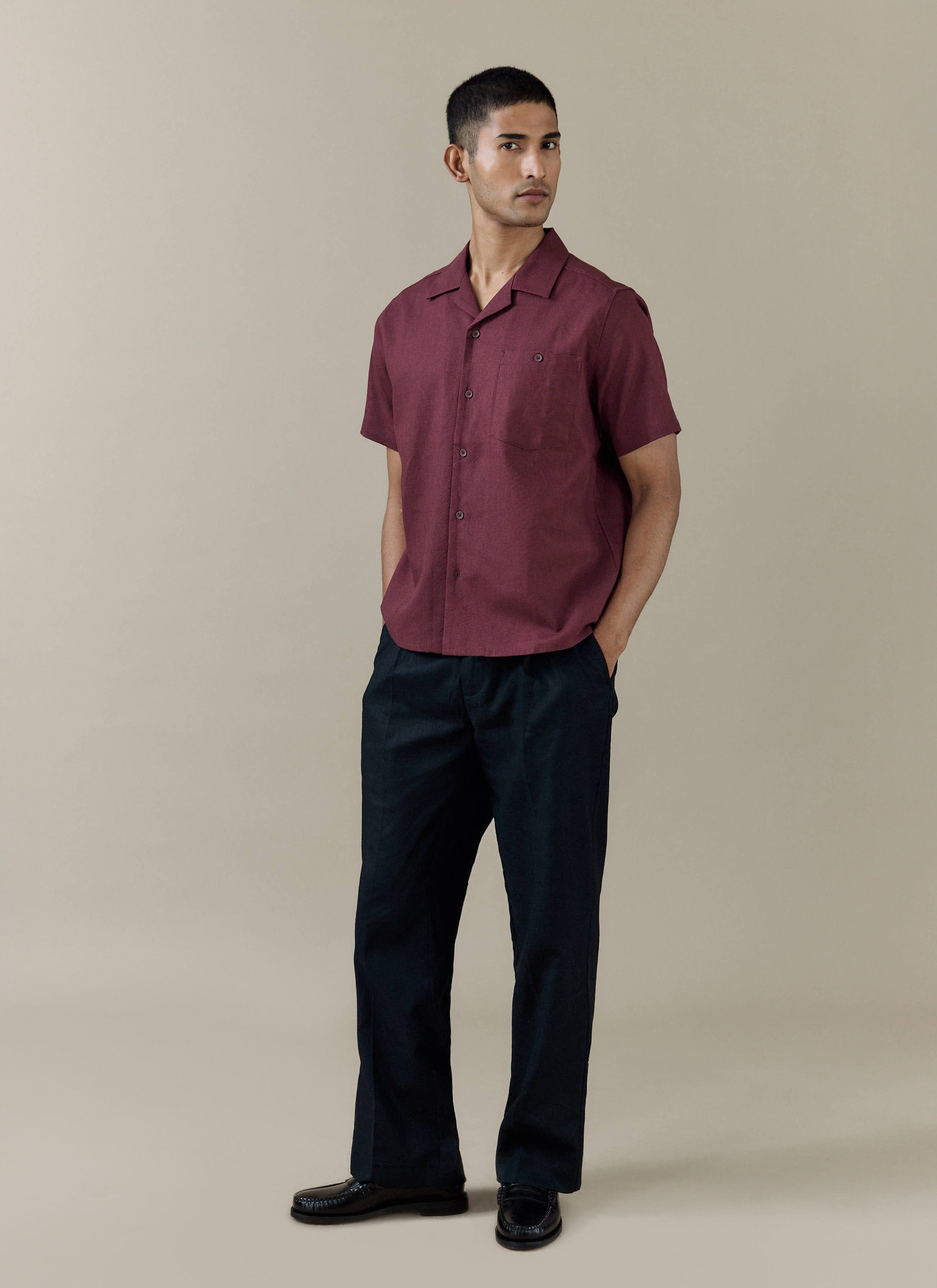 Percival Short Sleeve Cuban Shirt in a rich Merlot linen blend, styled with dark trousers and black leather loafers.