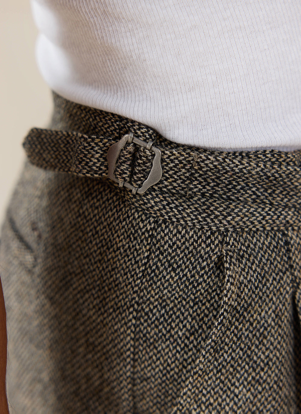 Percival Blake Double Pleated Tailored Trousers in grey birdseye wool, showing the metal side adjuster buckle.
