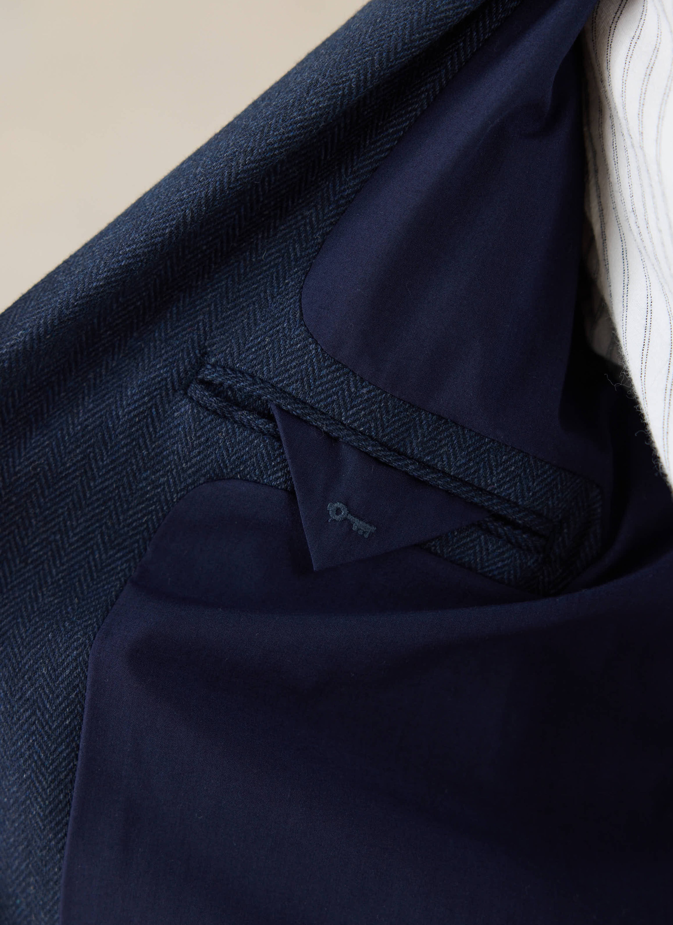 Percival Tailored Blazer in Navy Herringbone Wool interior detail with an internal pocket and key logo.
