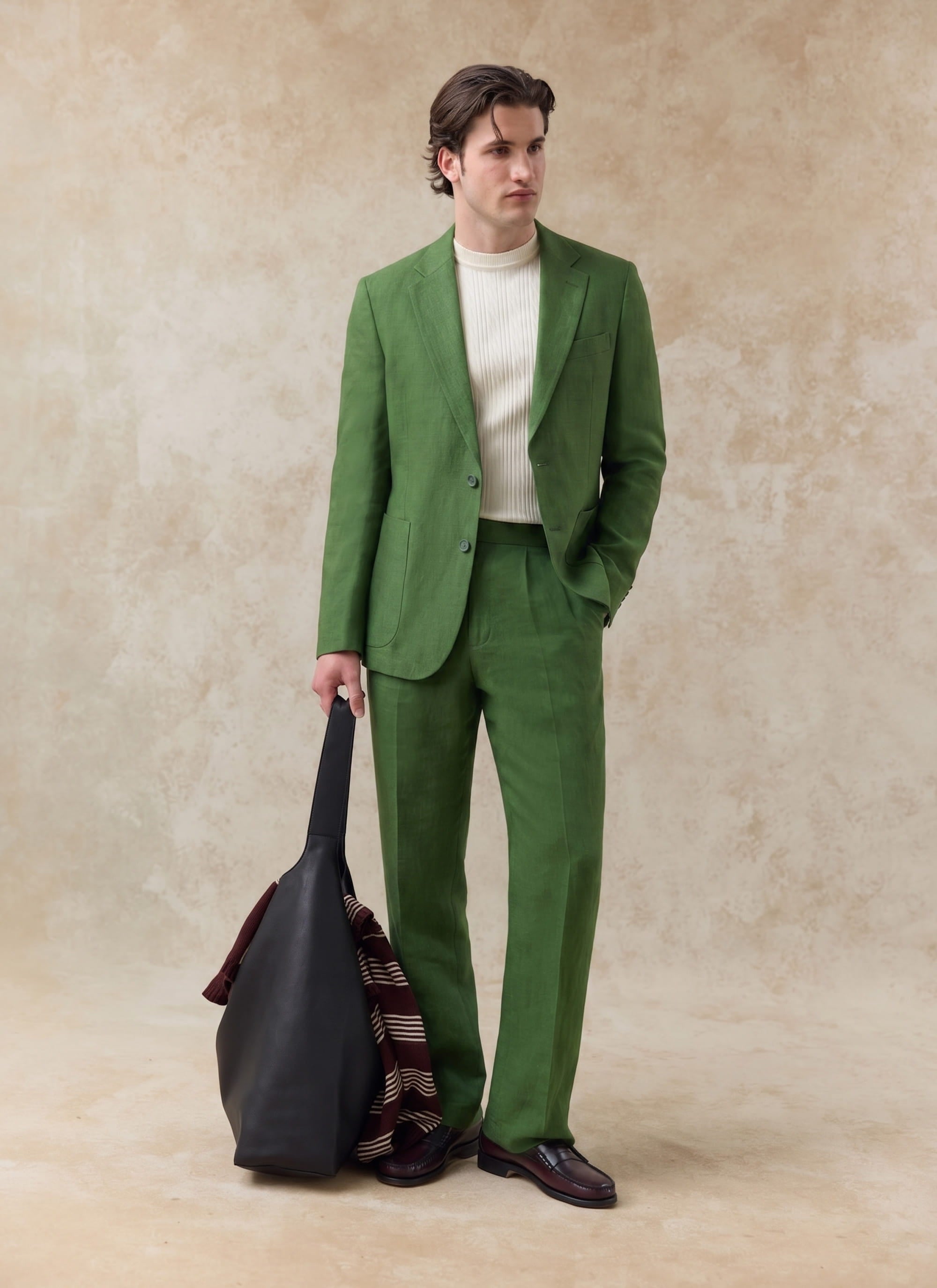 Percival Tailored Linen Blazer in forest green worn as a full linen suit with matching trousers and a cream knit.