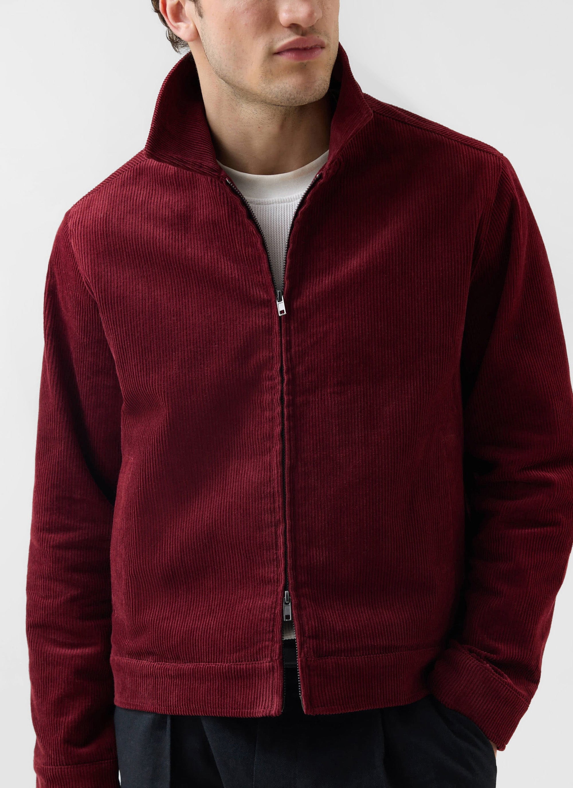 A man models the Percival Marcel Cord Jacket in burgundy, styled over a white t-shirt against a plain background.