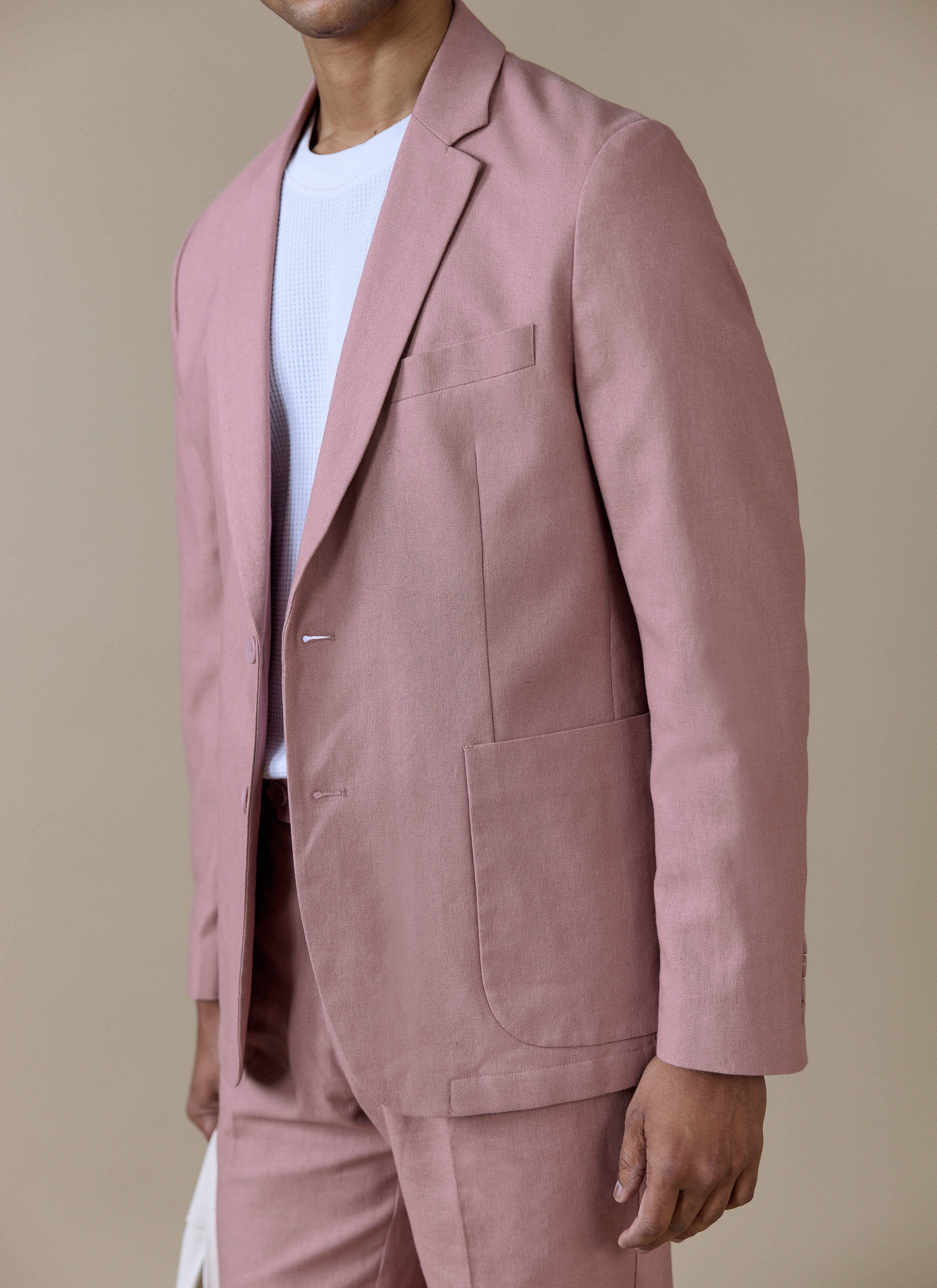 Dusty pink Percival Tailored Linen Blazer featuring a notch lapel and patch pockets, styled with matching trousers.
