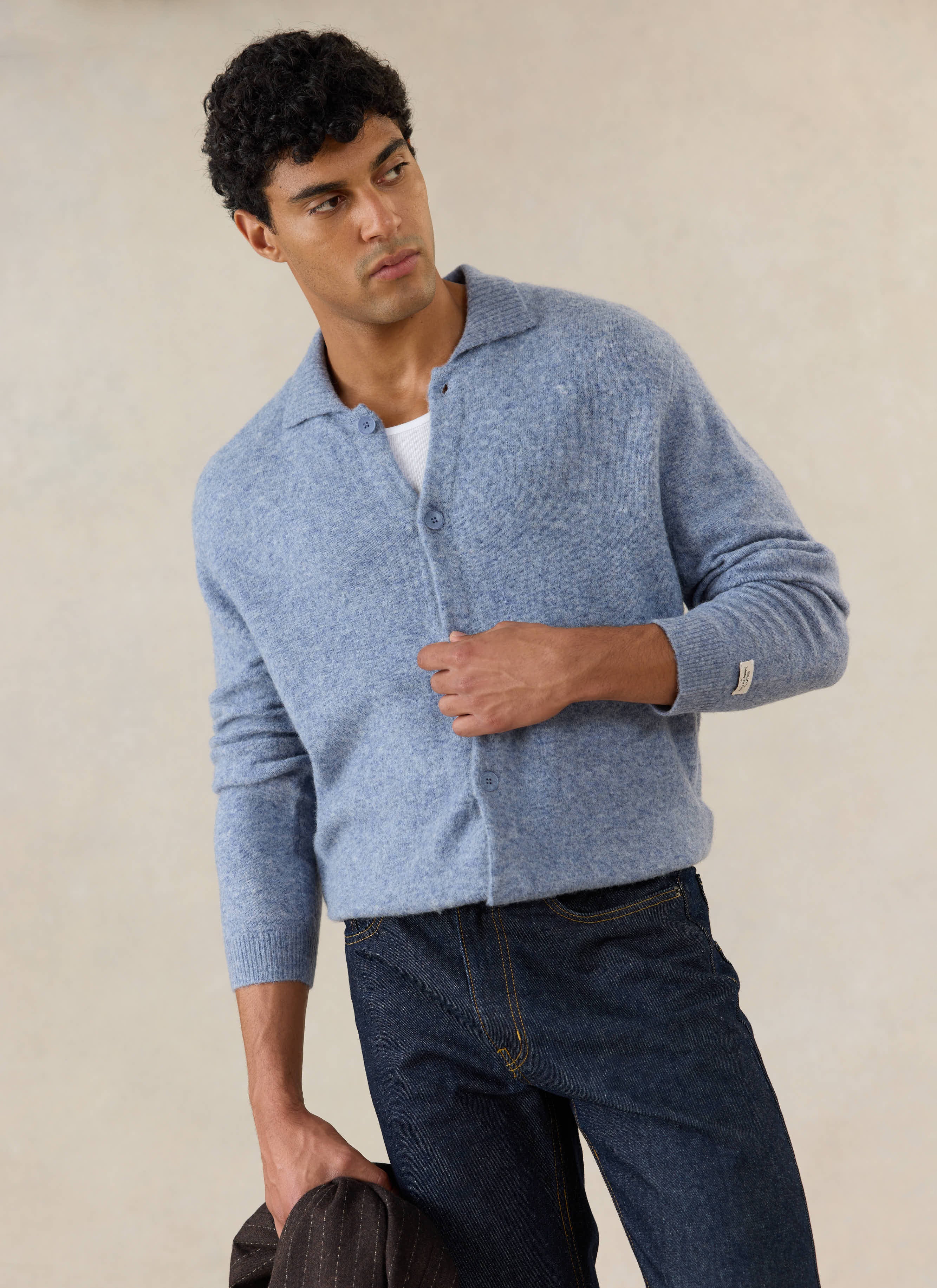 A model wears the heather blue Percival Archive Knit Collared Cardigan in yak wool, paired with dark denim jeans.