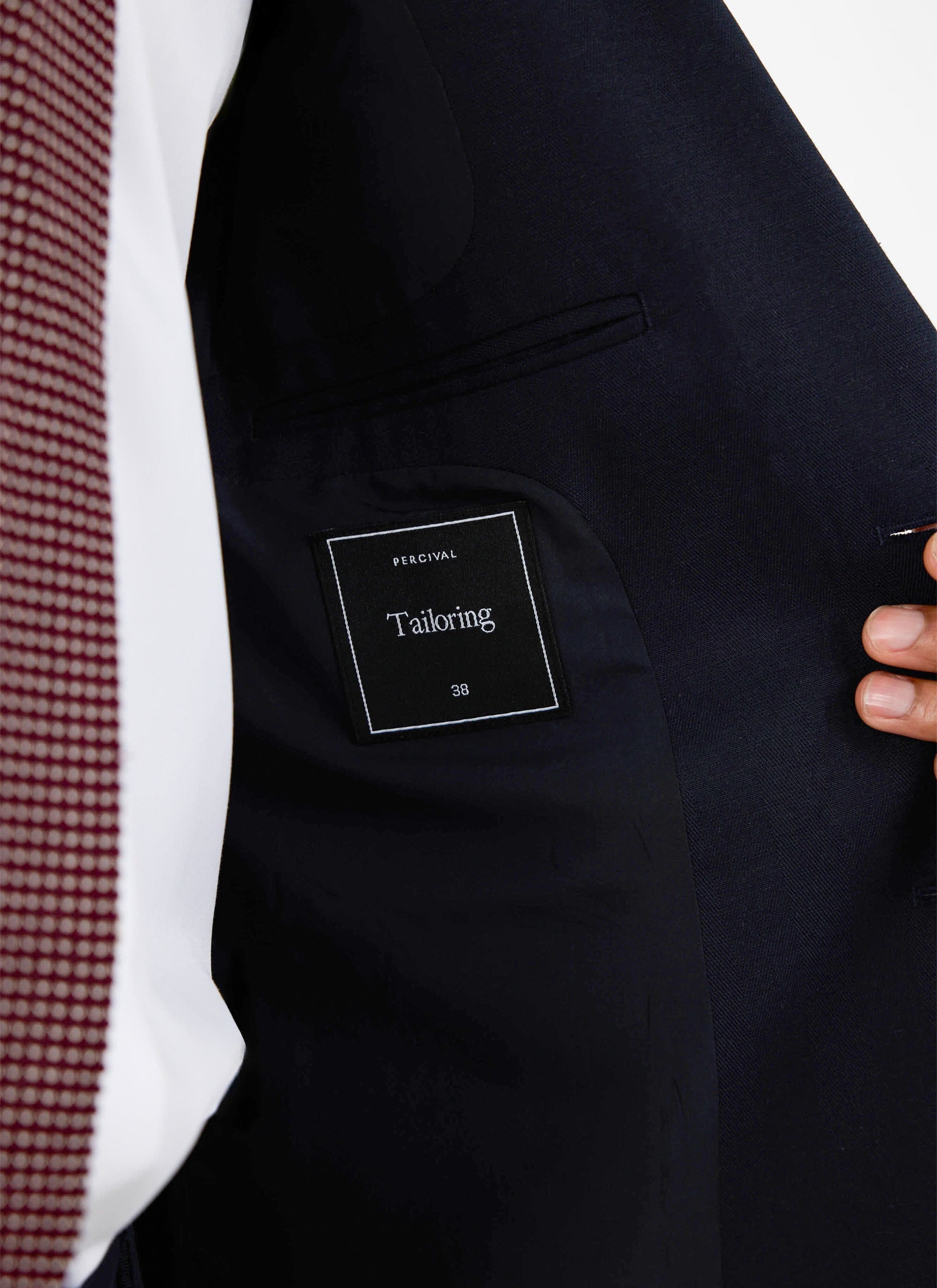 A close-up of the interior of the navy Lyocell Regular Blazer, showing the signature Percival 'Tailoring' label.
