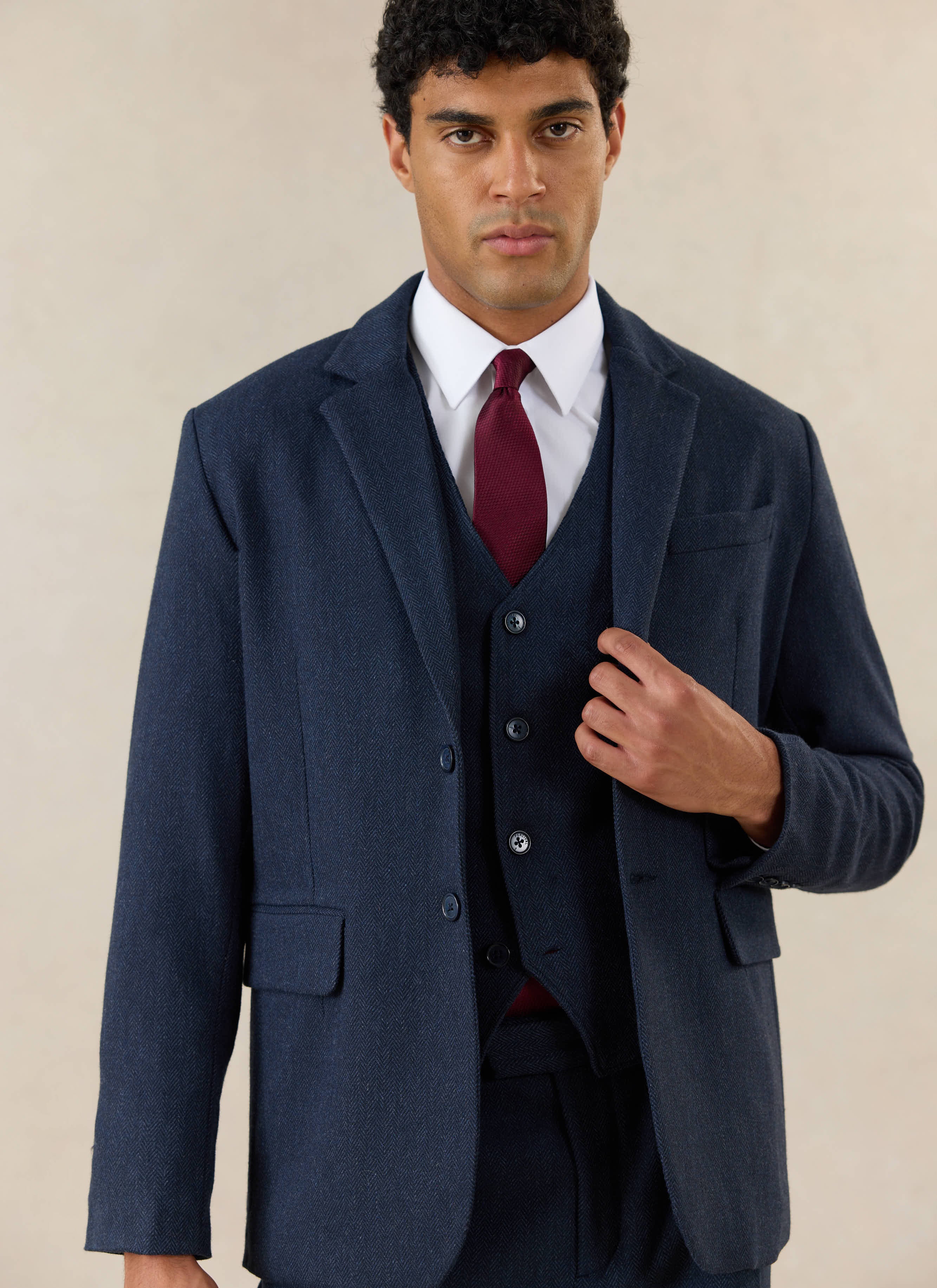 A model wears the Percival Stanley Tailored Blazer and Percival Stanley Tailored Waistcoat in navy herringbone wool.