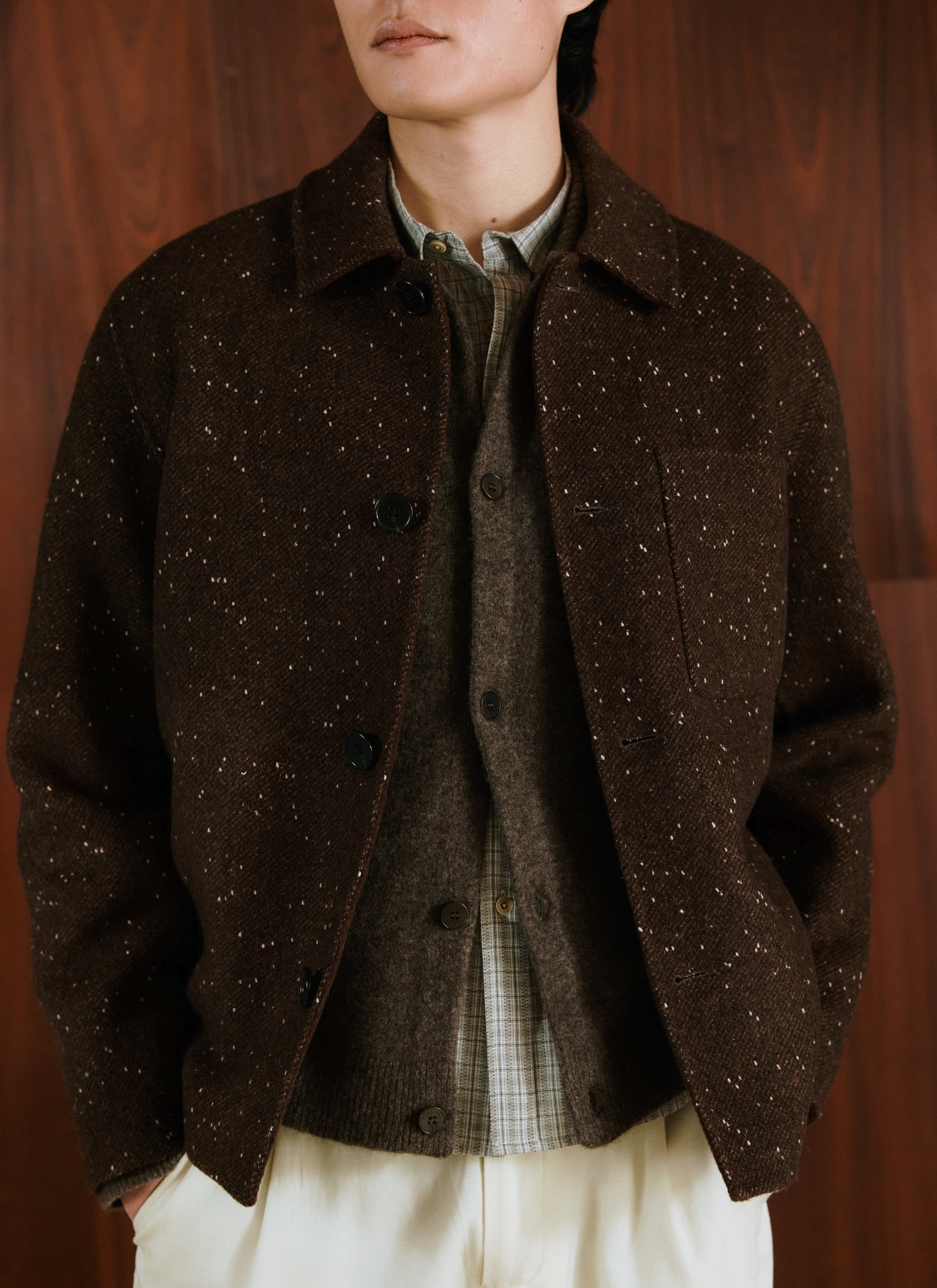 A model wearing the brown fleck Percival Minnesota Double-Faced Overshirt layered over a shirt and knitwear.