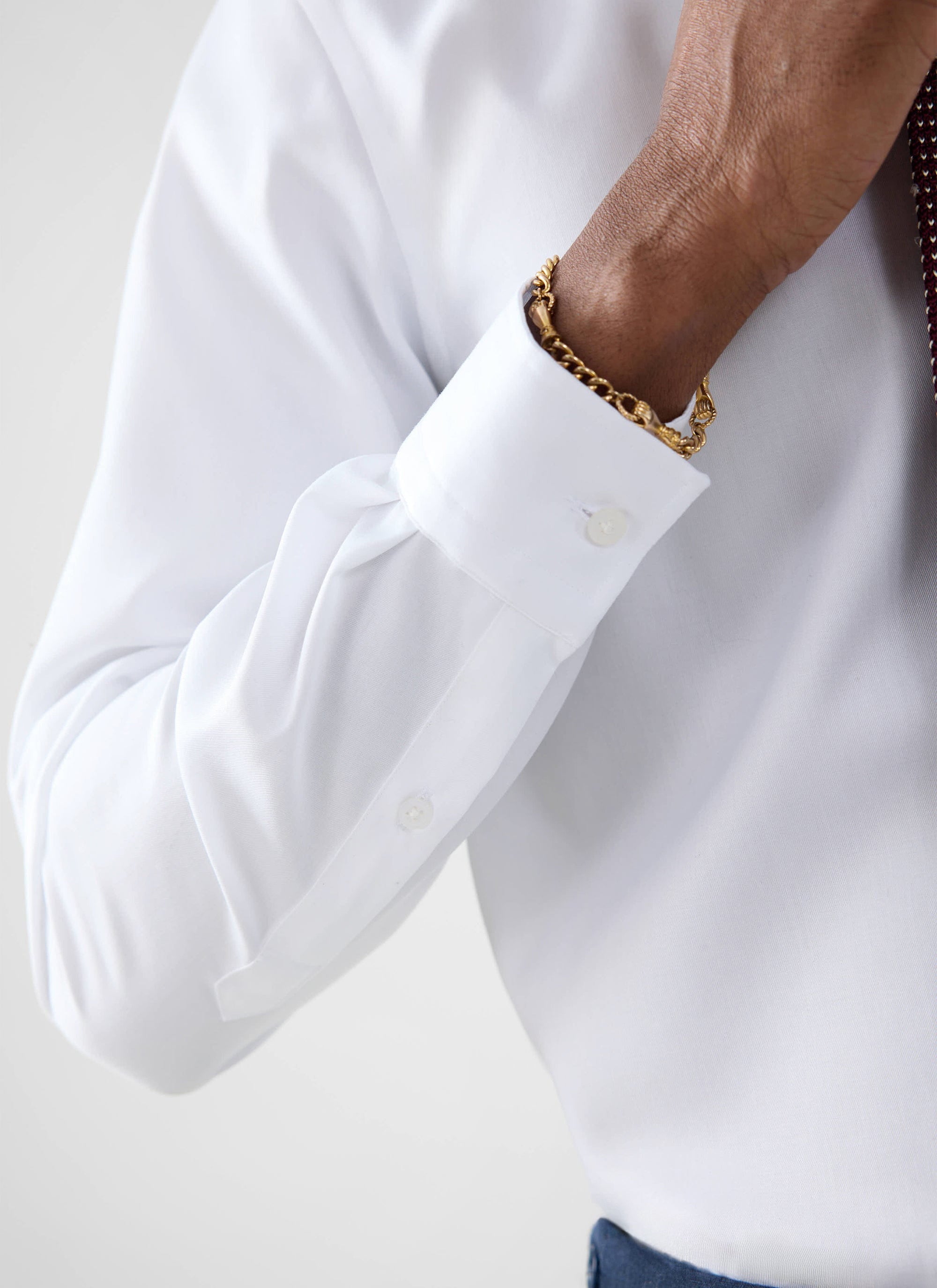 A close-up of a model wearing the Percival Formal Classic Shirt, showcasing the crisp white cotton poplin cuff.