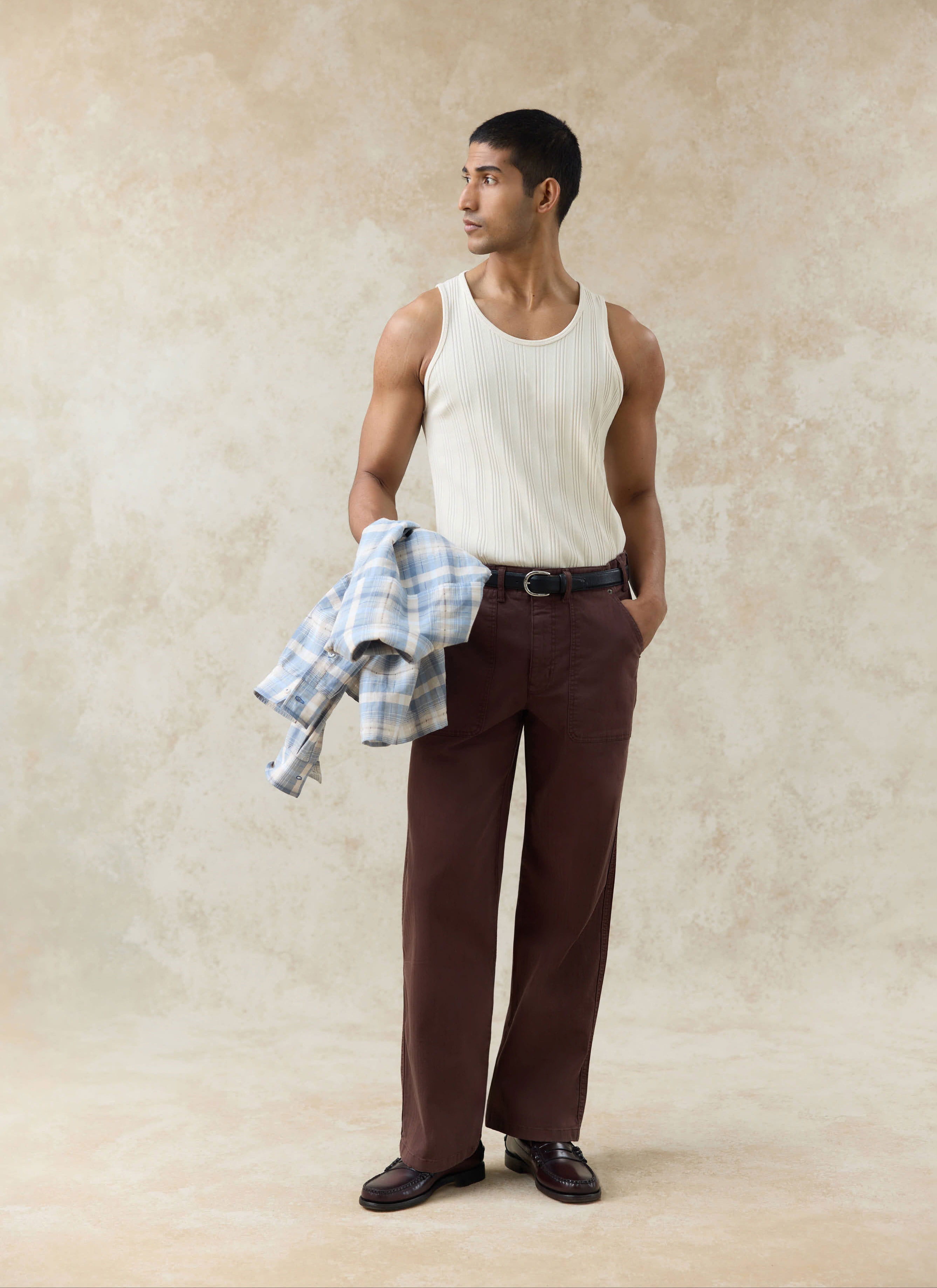 Percival Lungo Herringbone Straight Trousers in espresso brown cotton herringbone, styled with a white ribbed tank top.