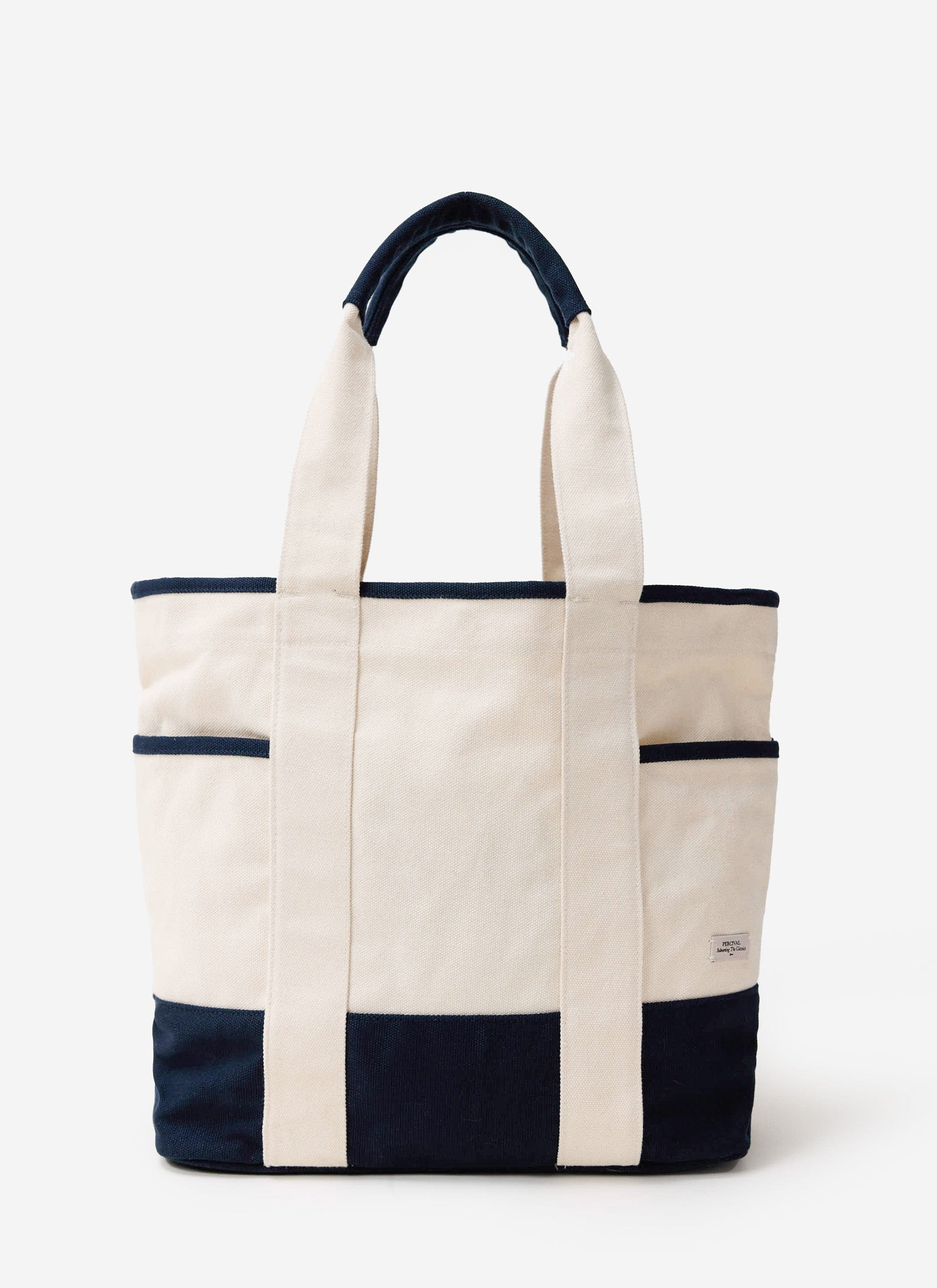 The Percival Tote Bag in ecru and navy cotton canvas, shot front-on against a white background.
