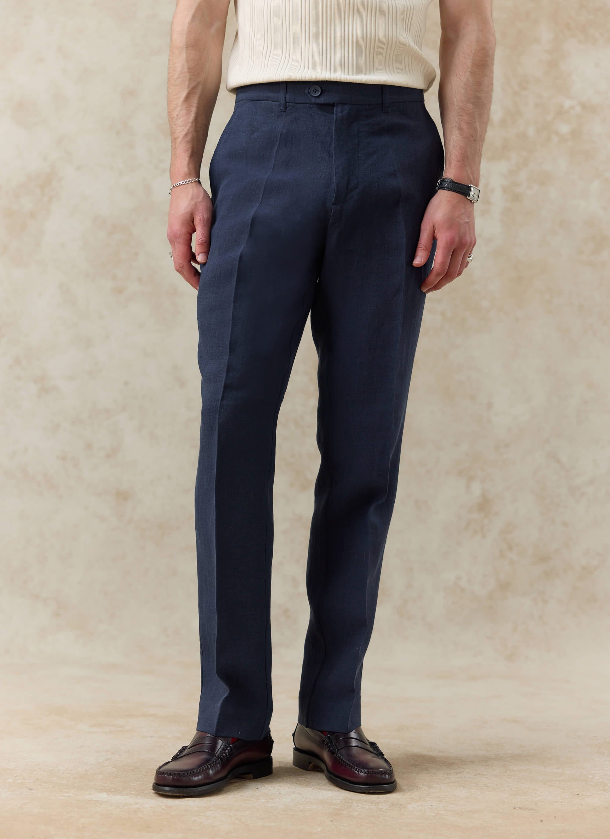Percival navy blue tailored linen trousers with a straight leg fit, shown on a model with a cream shirt and loafers.