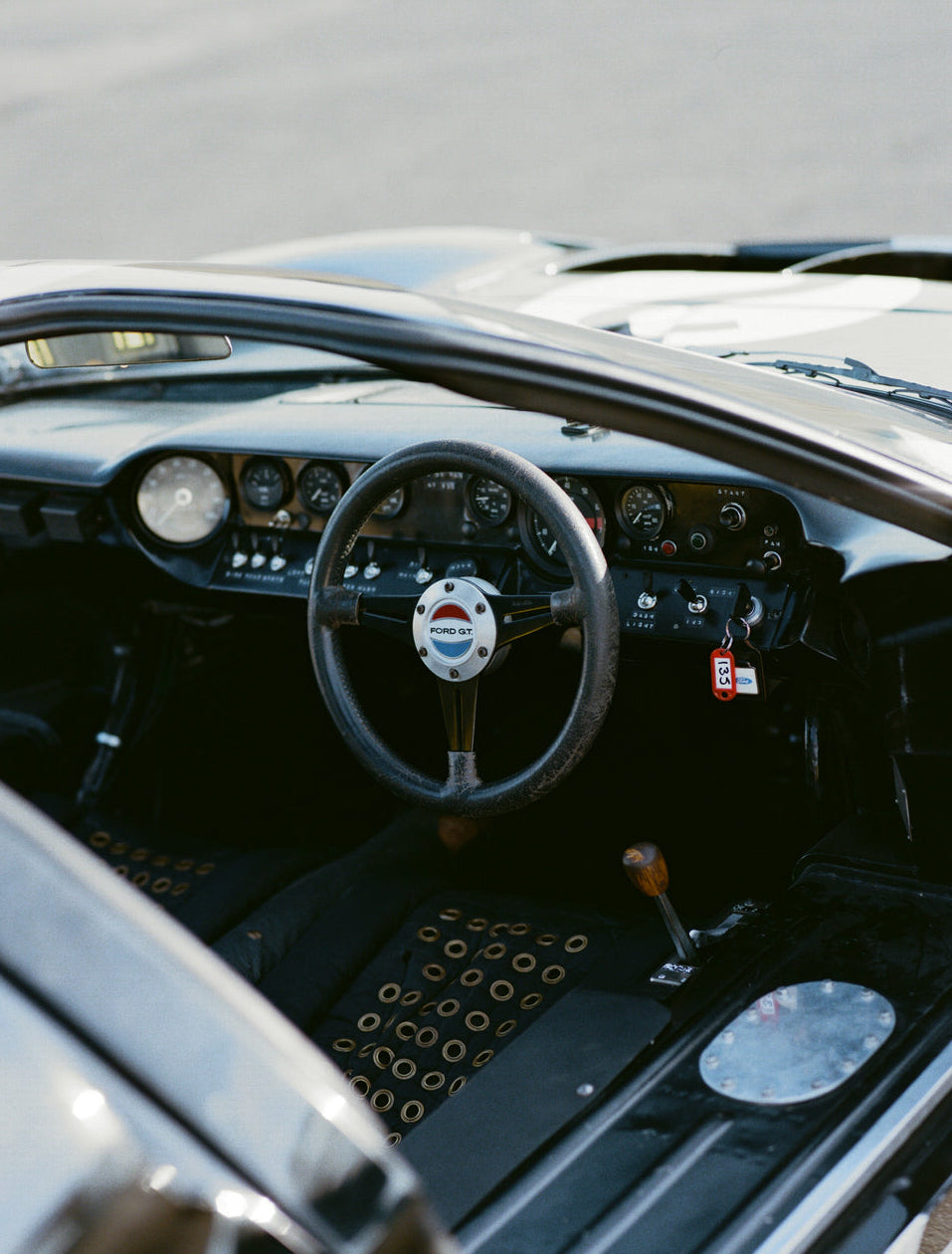 Vintage Ford GT interior featuring a classic racing dashboard and steering wheel for the Ford x Percival collection.