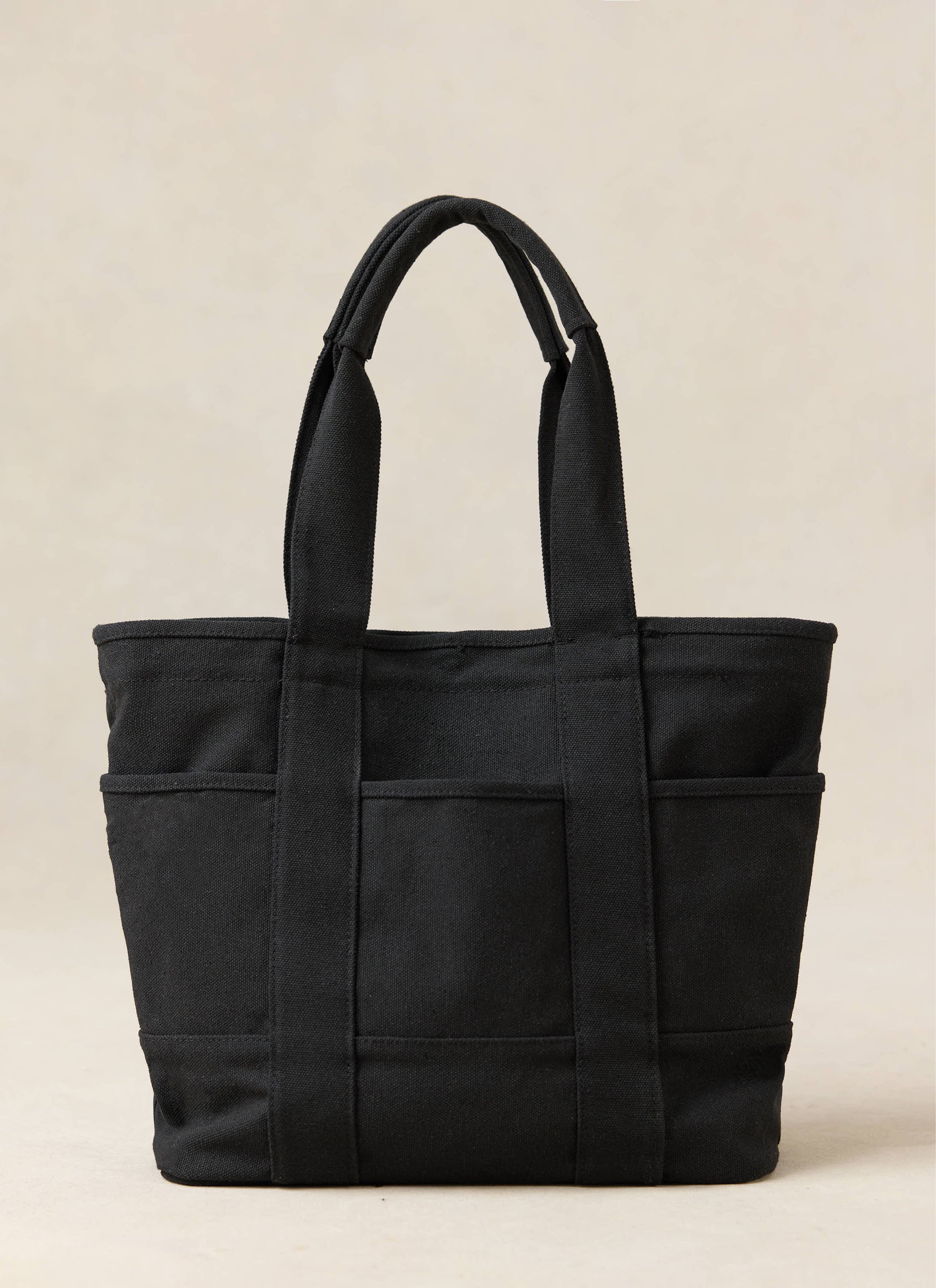 Black Ford x Percival GT40 tote bag featuring external pockets and sturdy top handles in a canvas-style blend.