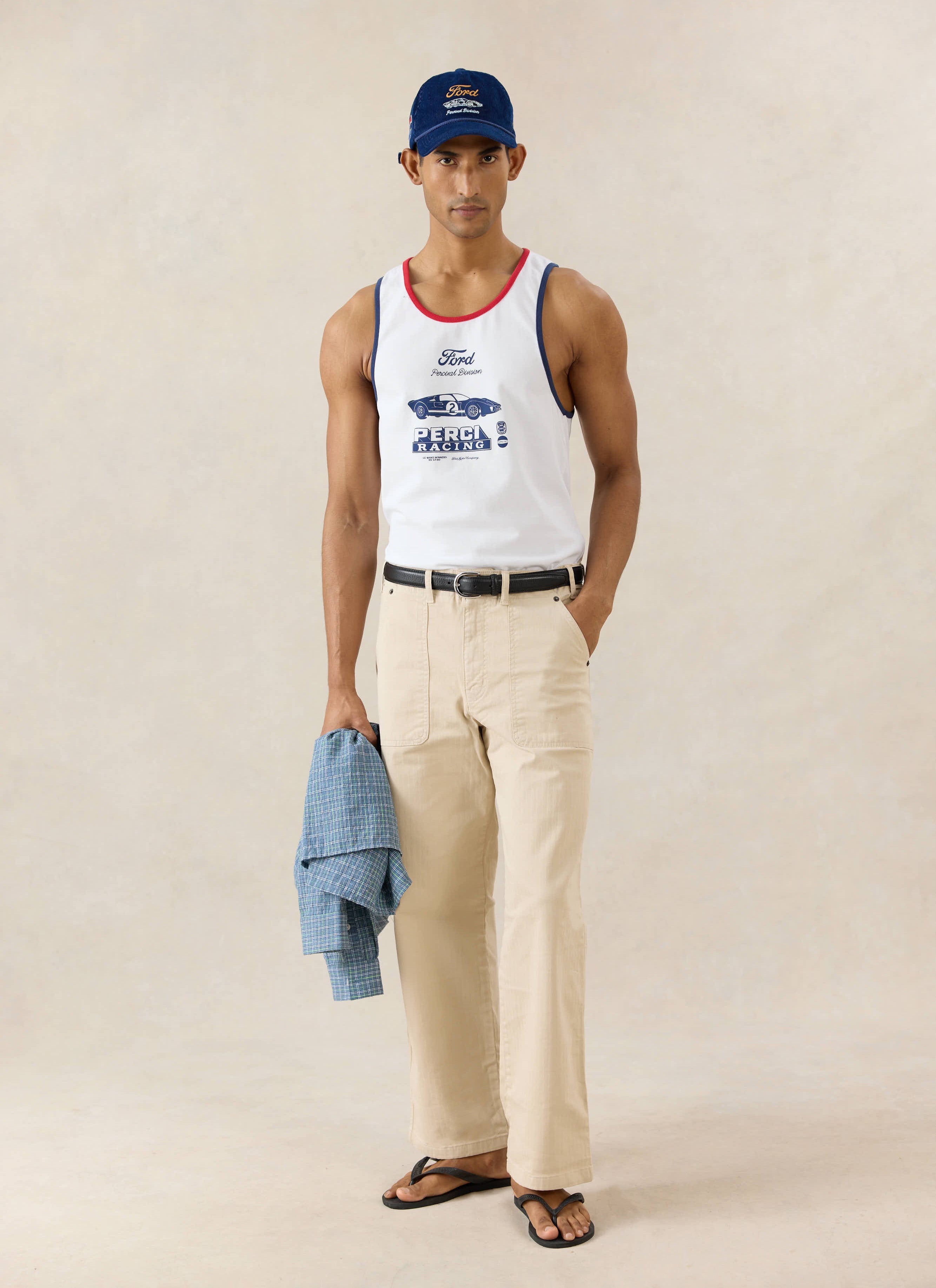 White Ford x Percival GT40 ringer vest styled with cream trousers and a navy cap from the Percival collection.