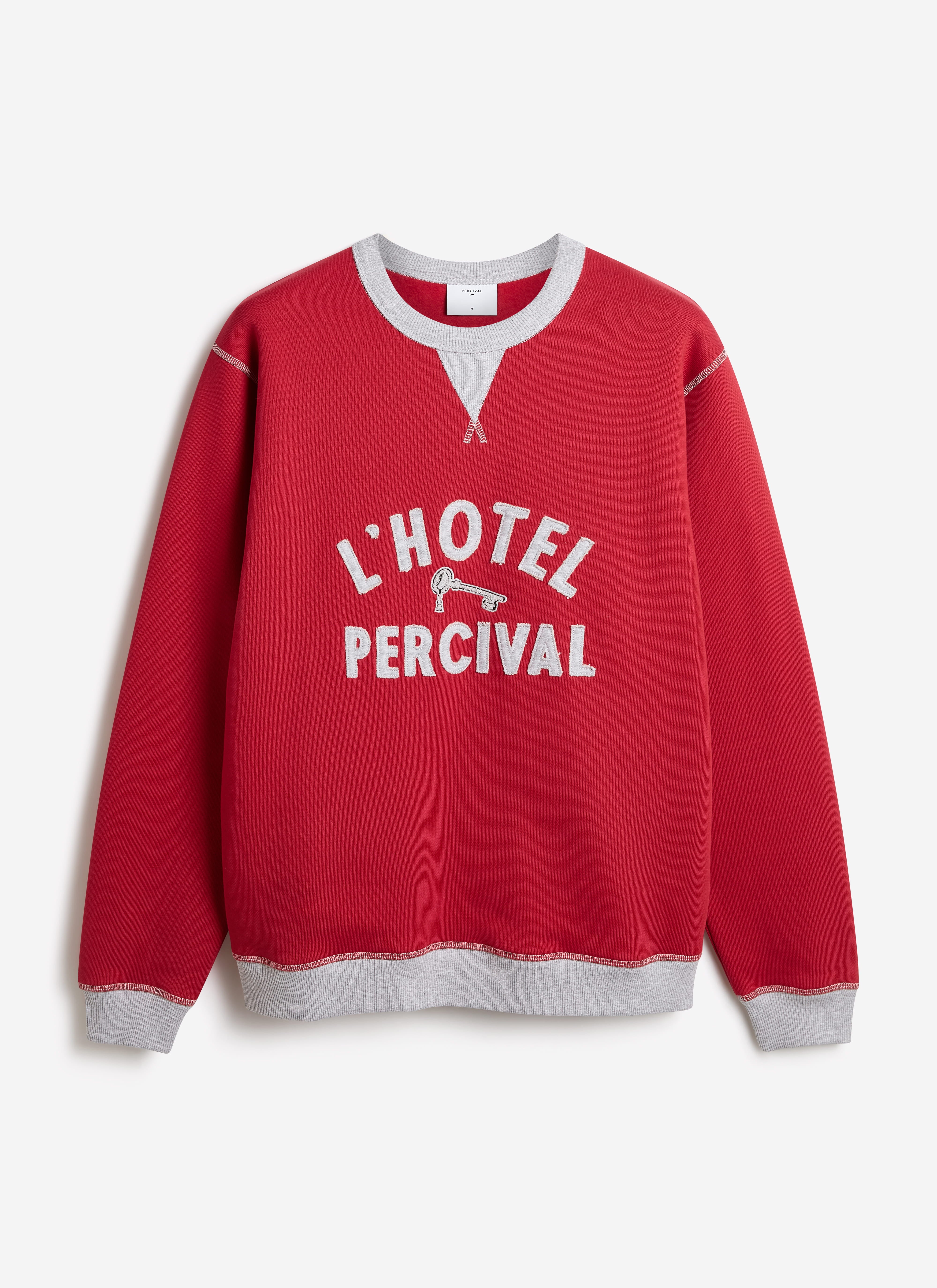 Red organic cotton Ronald sweatshirt by Percival with grey ribbed trims and a collegiate L'Hotel Percival appliqué.