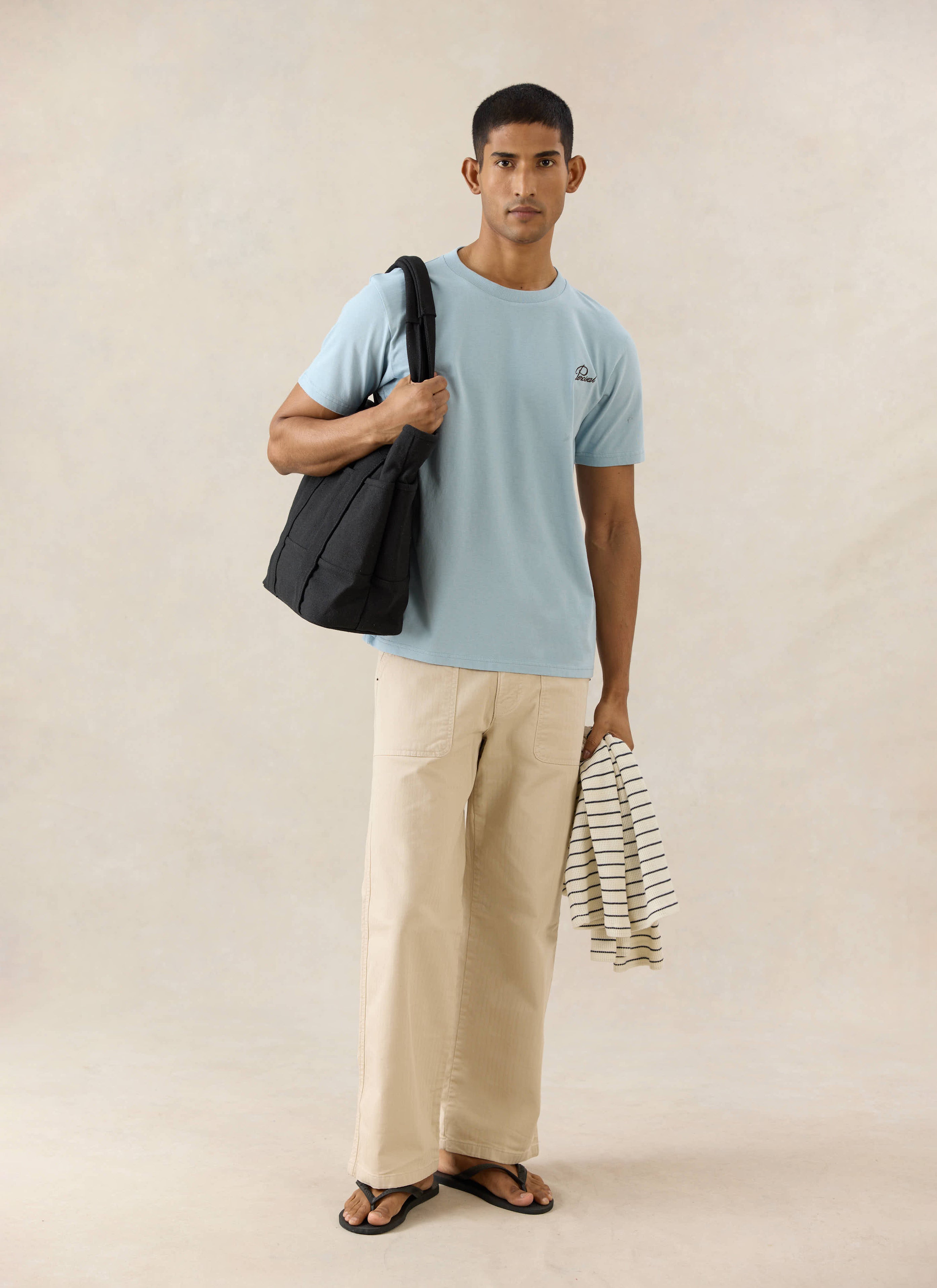 Percival light blue script embroidered organic cotton t-shirt, styled with Lucas carpenter trousers in beige.