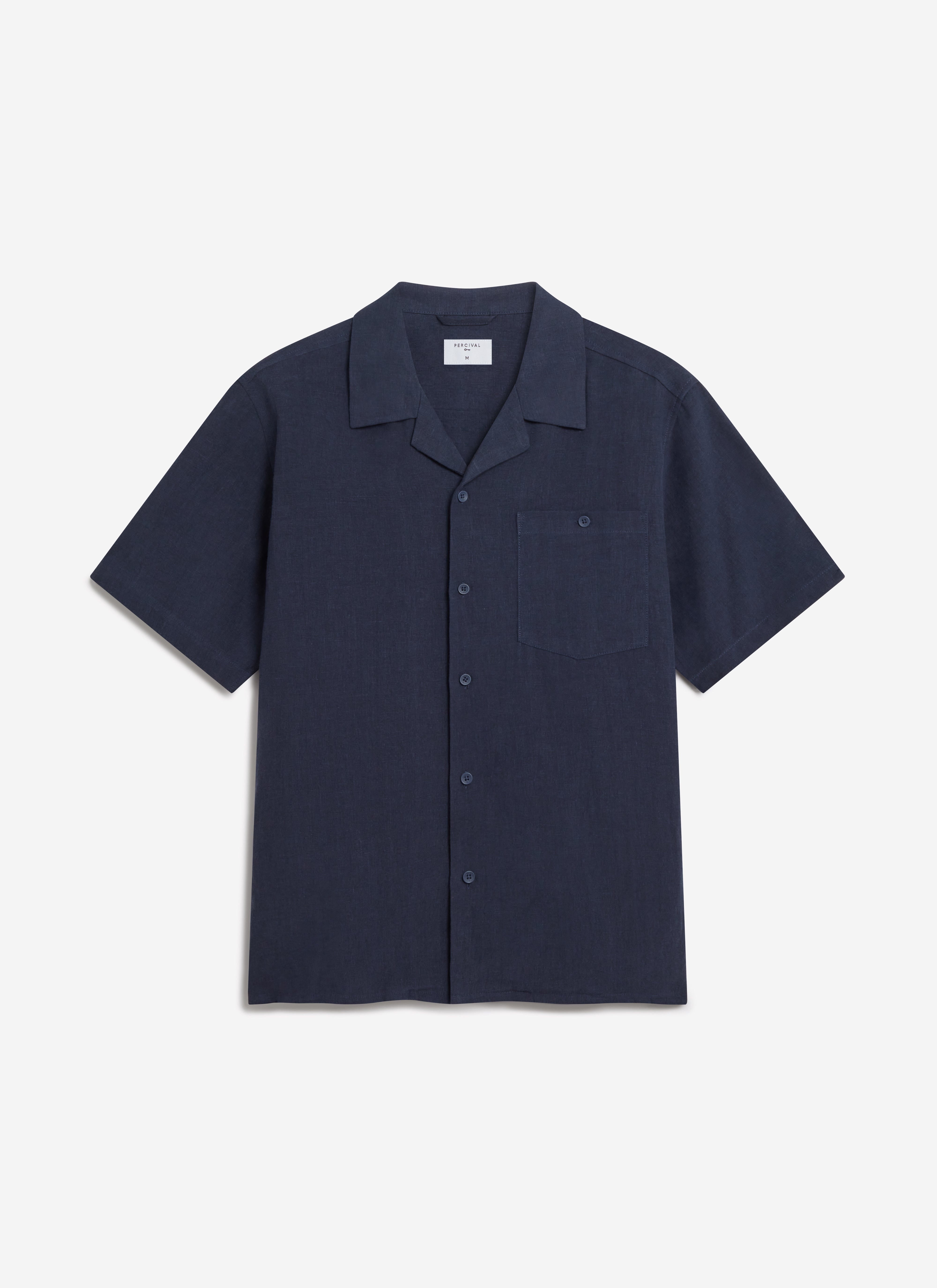 A flat lay of the Percival Short Sleeve Cuban Shirt in navy linen, showing the cuban collar and chest pocket.