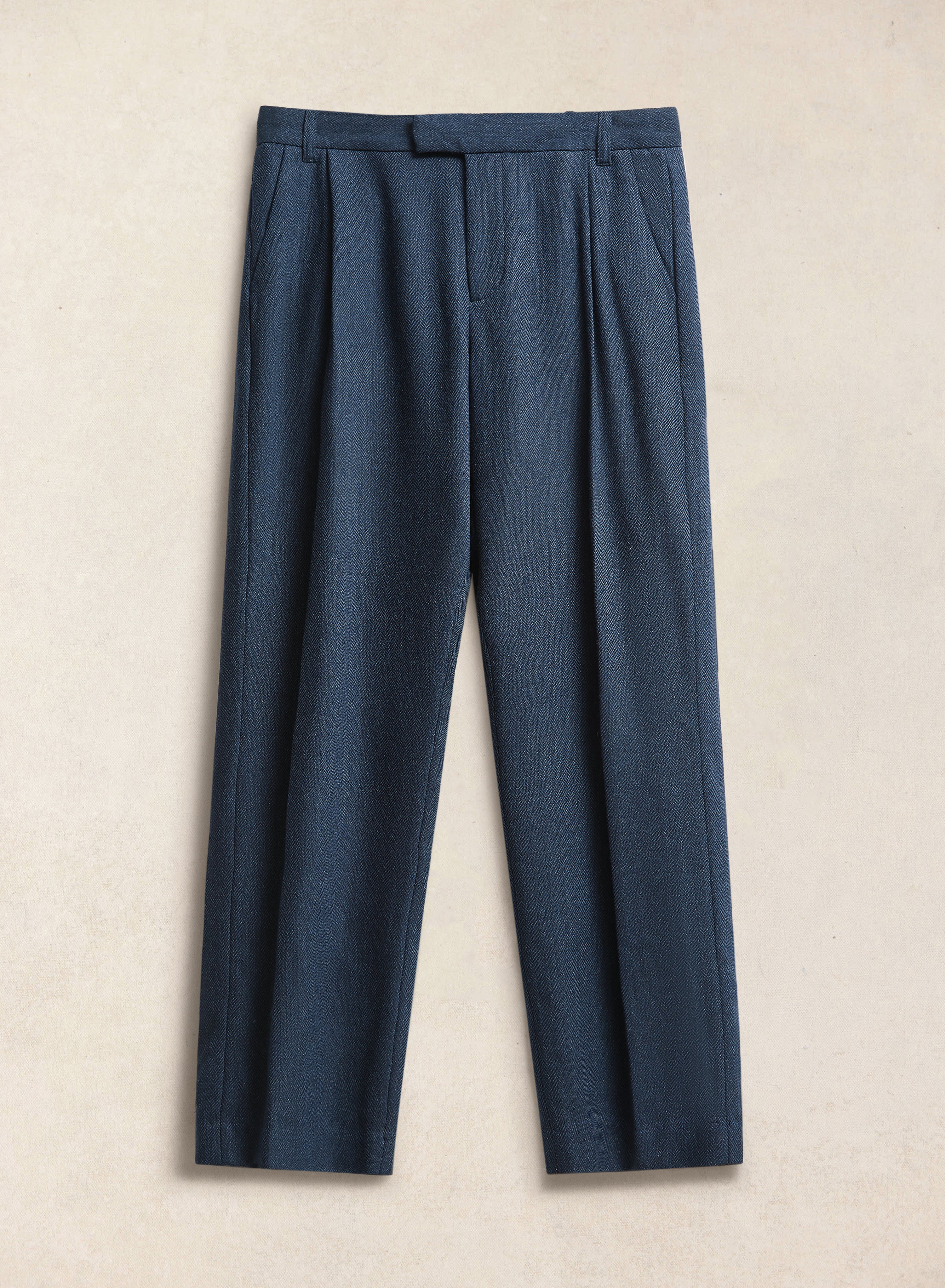 Percival Stanley navy herringbone wool pleated tailored trousers, featuring a pleated front and clean straight leg.