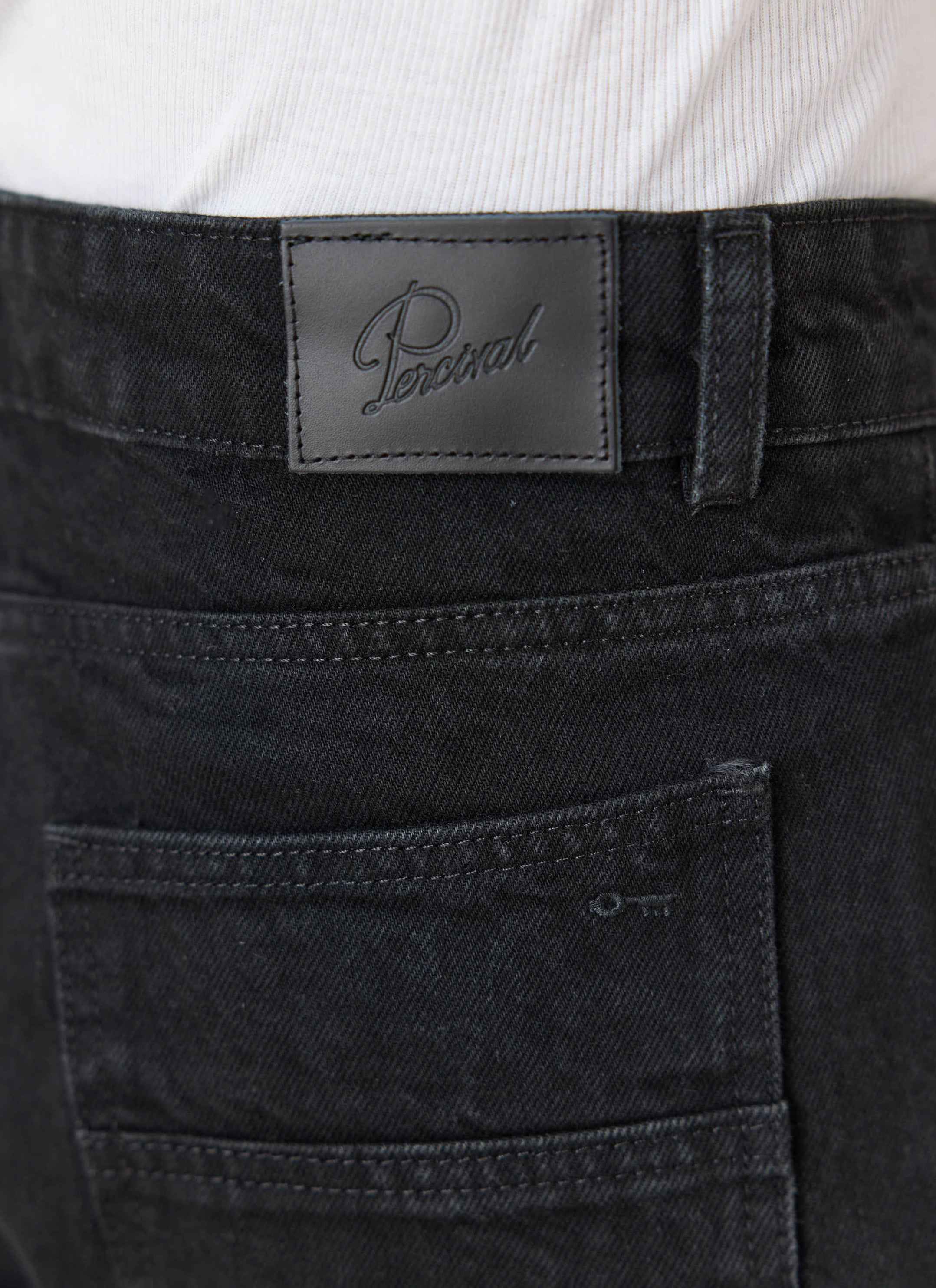 Black Percival Heritage denim jeans showing the embossed leather patch, 14oz cotton and back pocket embroidery.