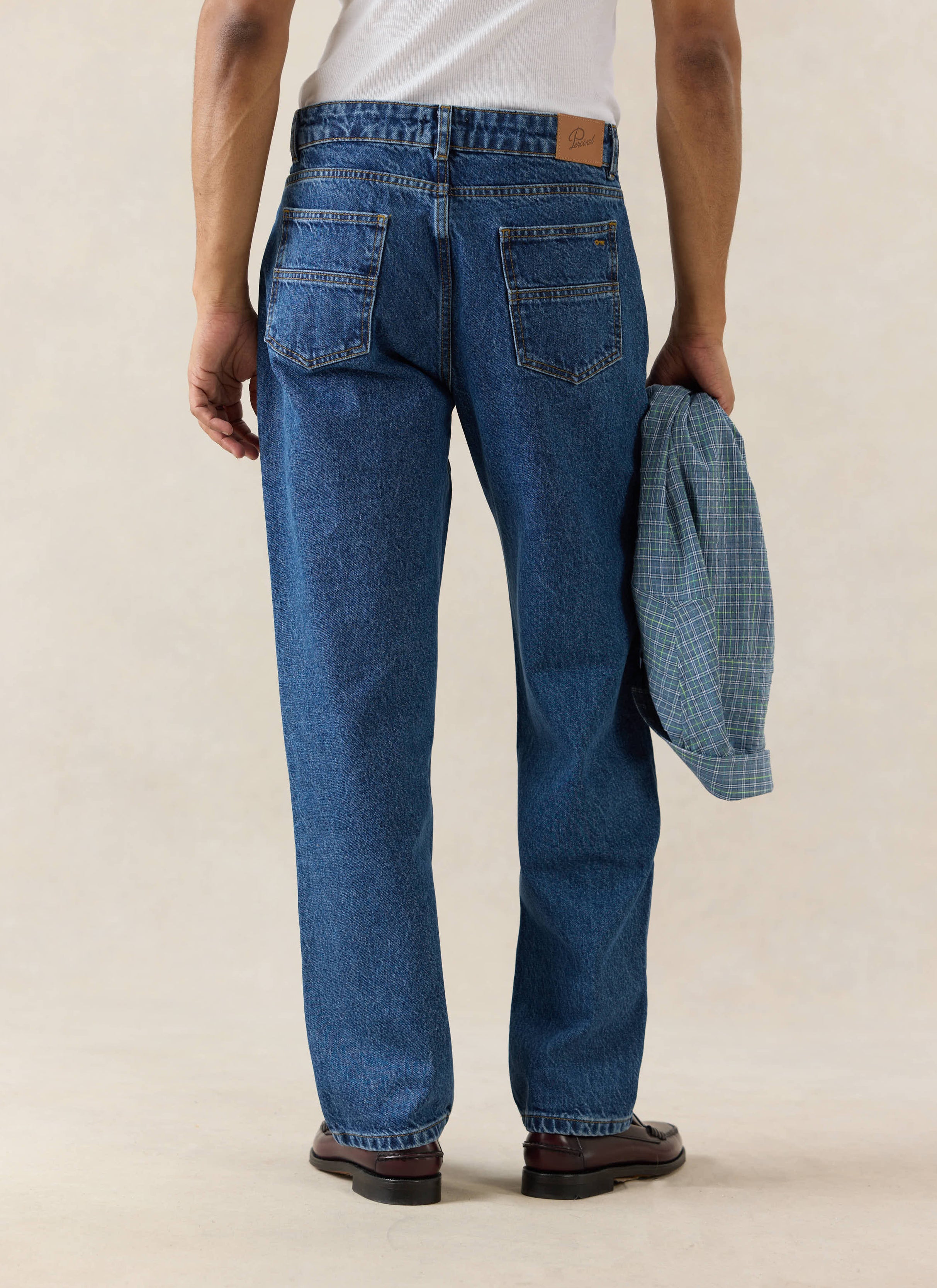 Percival Heritage straight-leg jeans in mid-wash blue, featuring structured 14oz denim and a signature leather back patch.