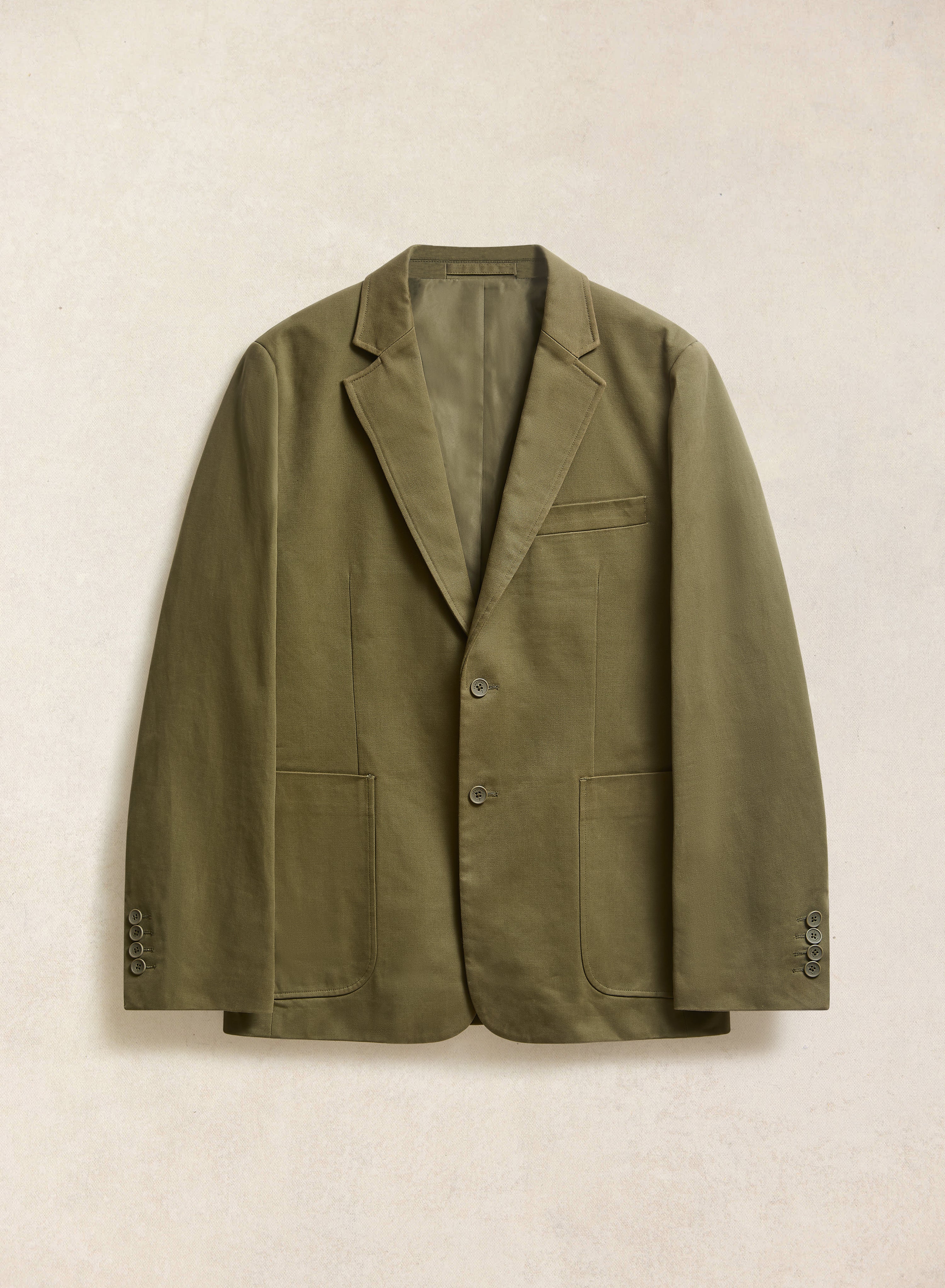 The Percival Forest Green Tailored Blazer in brushed moleskin, featuring notch lapels and two patch pockets.