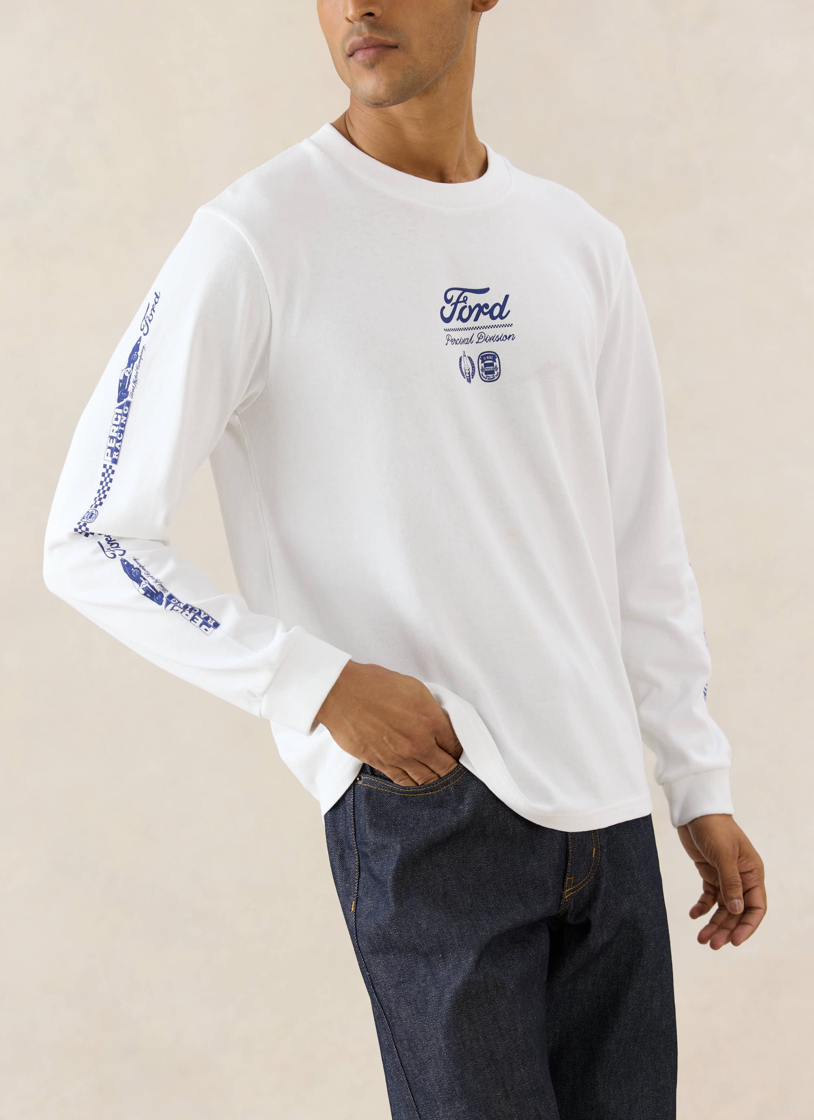 White Ford x Percival long sleeve t-shirt with motorsport graphics, styled with straight-leg heritage raw denim jeans.