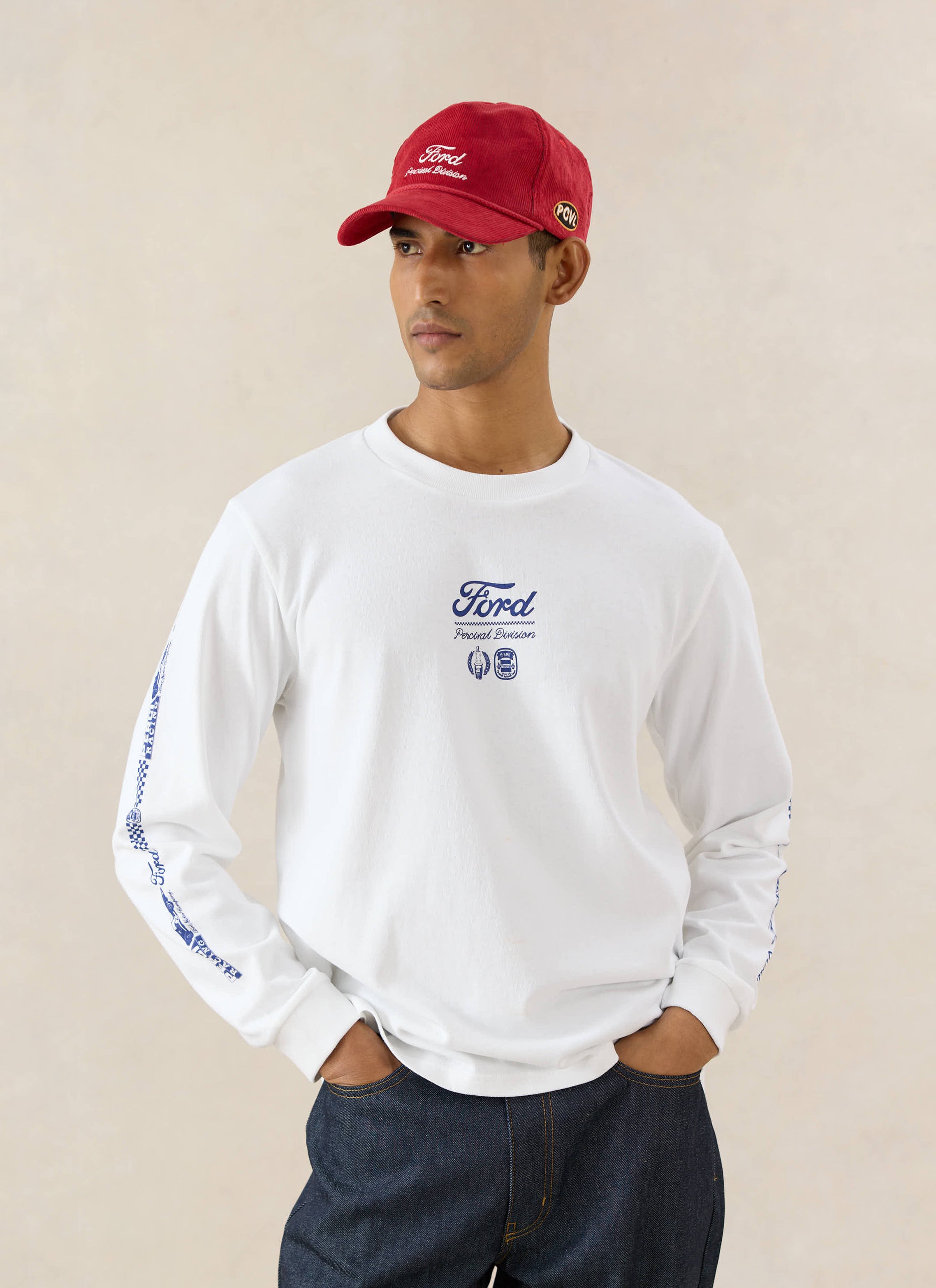 A model wears the white Ford x Percival Triple Triumph organic cotton long sleeve t-shirt with dark indigo heritage denim.