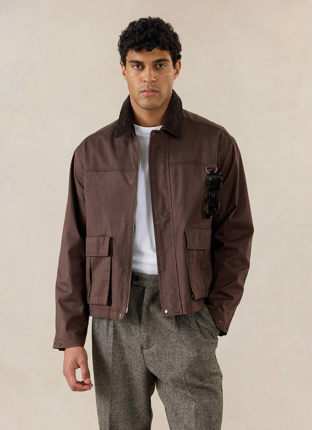 A model wears the Percival espresso brown wax zip jacket with utility pockets and a stand collar.