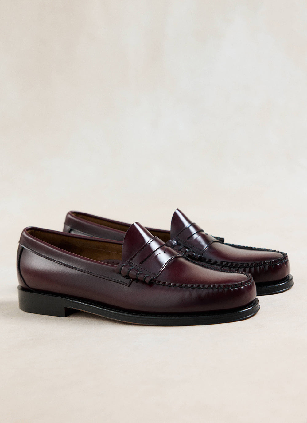 G.H. Bass Weejun Larson penny loafers in polished wine leather, featuring a classic slip-on design and handsewn details.