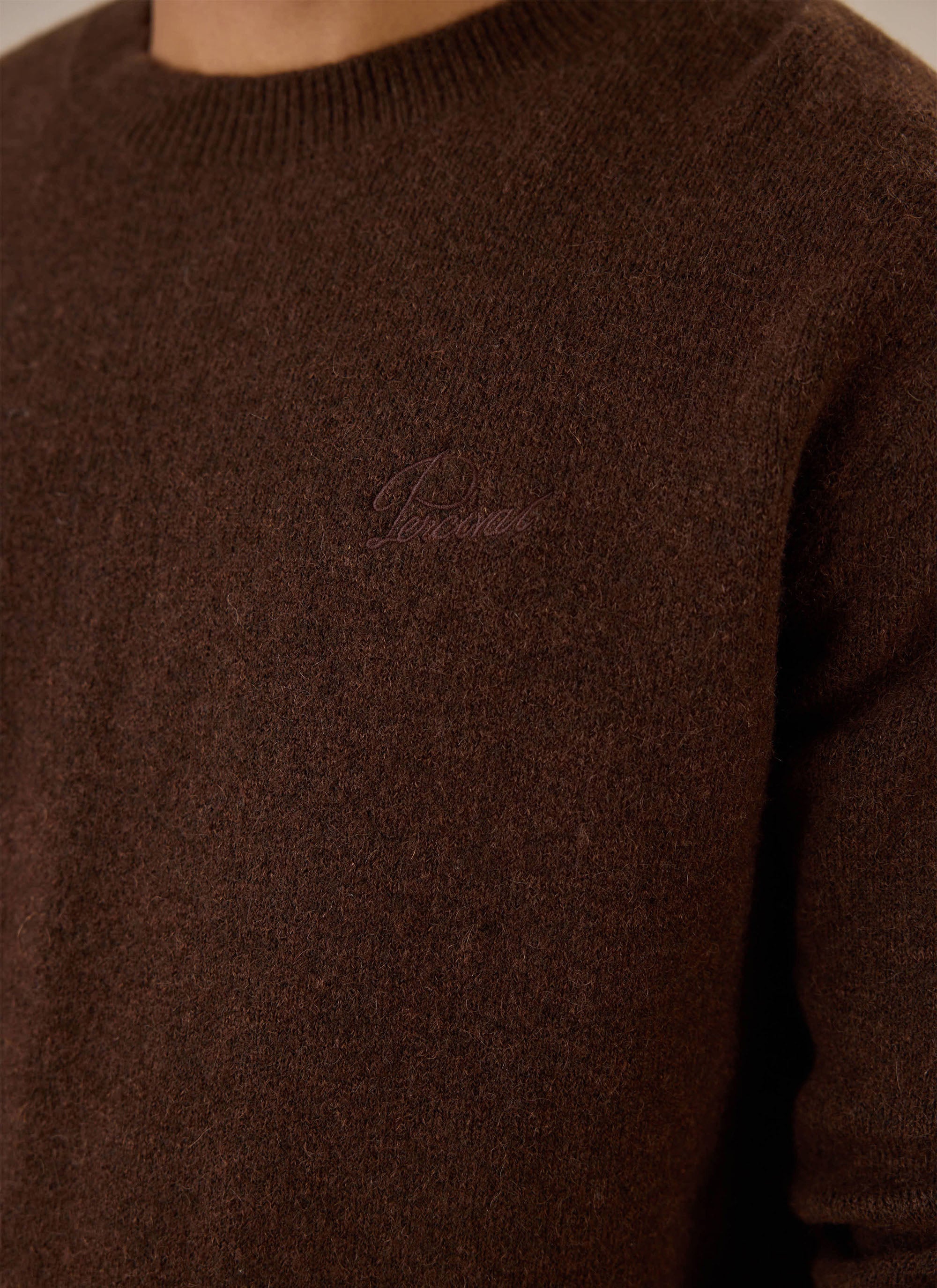 Close-up of the espresso brown Percival mohair boxy crew neck jumper highlighting the chest embroidery.