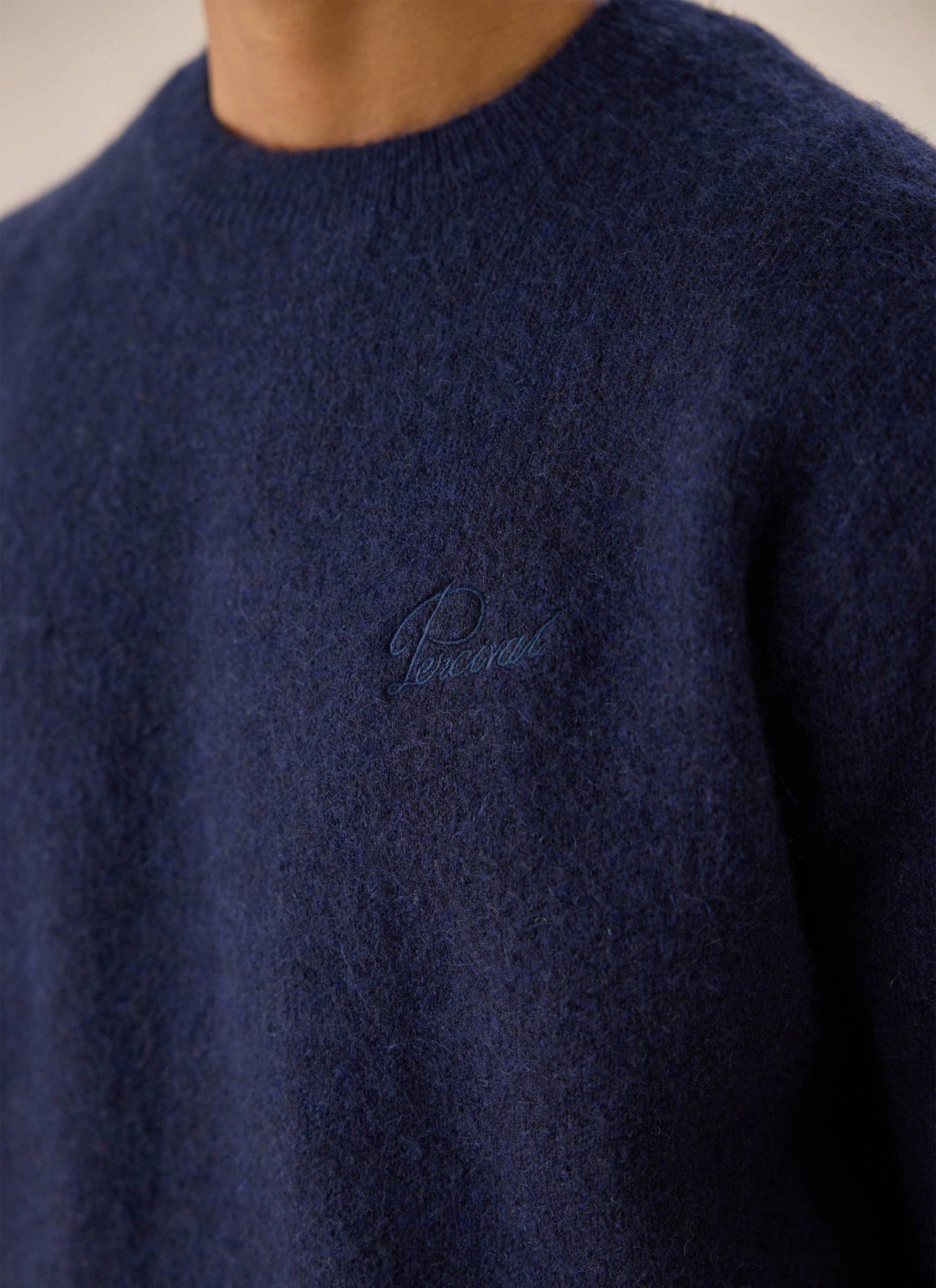 Close-up of a model wearing the navy Percival White Glove Boxy Crew Neck Jumper, showing the fuzzy mohair texture.