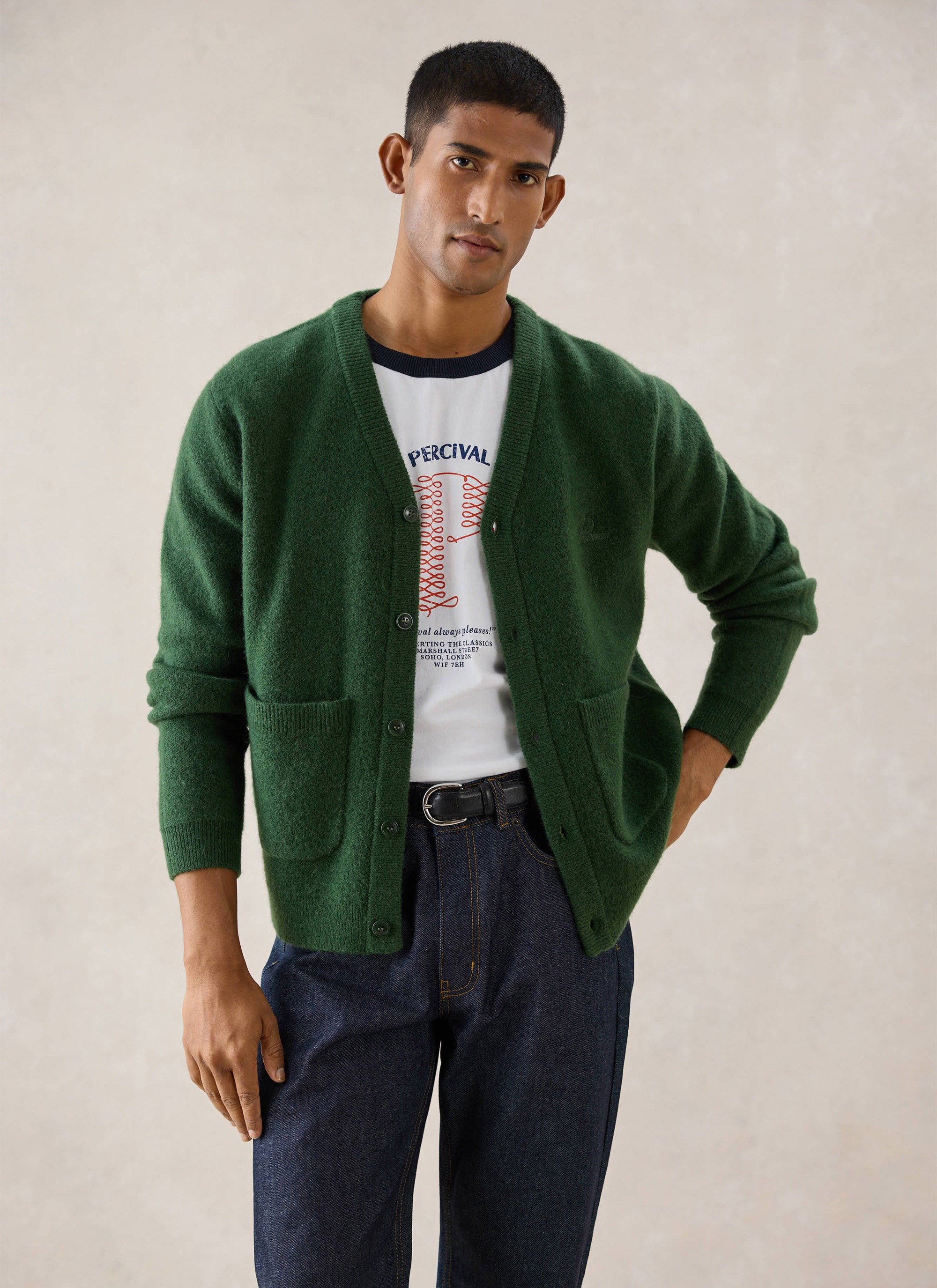 A model wearing a Percival forest green mohair wool blend White Glove cardigan over a white t-shirt and jeans.