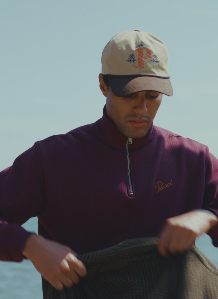 Beige Percival Tucker soft trucker cap in brushed cotton with embroidered details, styled with the Conrad 1/4 zip jumper.