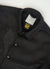 close up of black jacket with black embroidery of and ice cream and a tomato