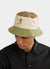 green, beige, brown and pink bucket hat with embroidery of a yellow chilli