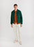 forest casentino wool bomber jacket styled wit rust knit shirt and white trousers