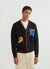 black cardigan with a yellow chilli and blue pepper on the front, and a tomato on the back
