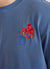 Blue t shirt with orange octopus embroidery on left chest close up