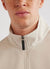 Ecru track jacket with orange octopus embroidery on left chest, collar close up