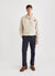 Ecru track jacket with orange octopus embroidery on left chest, styled with black trousers