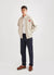 Ecru track jacket with orange octopus embroidery on left chest, styled with black trousers