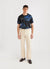 Black football shirt with large navy octopus prints, styled with ecru trousers