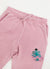 Pink trackpants with blue octopus embroidery on left thigh, close up