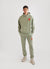 Pistachio green trackpants with orange octopus embroidery on left thigh, styled with matching pistachio green hoodie