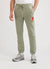 Pistachio green trackpants with orange octopus embroidery on left thigh