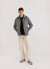 grey casentino overshirt styled with black boucle wool crew neck, beige trousers and grey sneakers