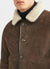close up of brown suede and white shearling coat with collar and buttons